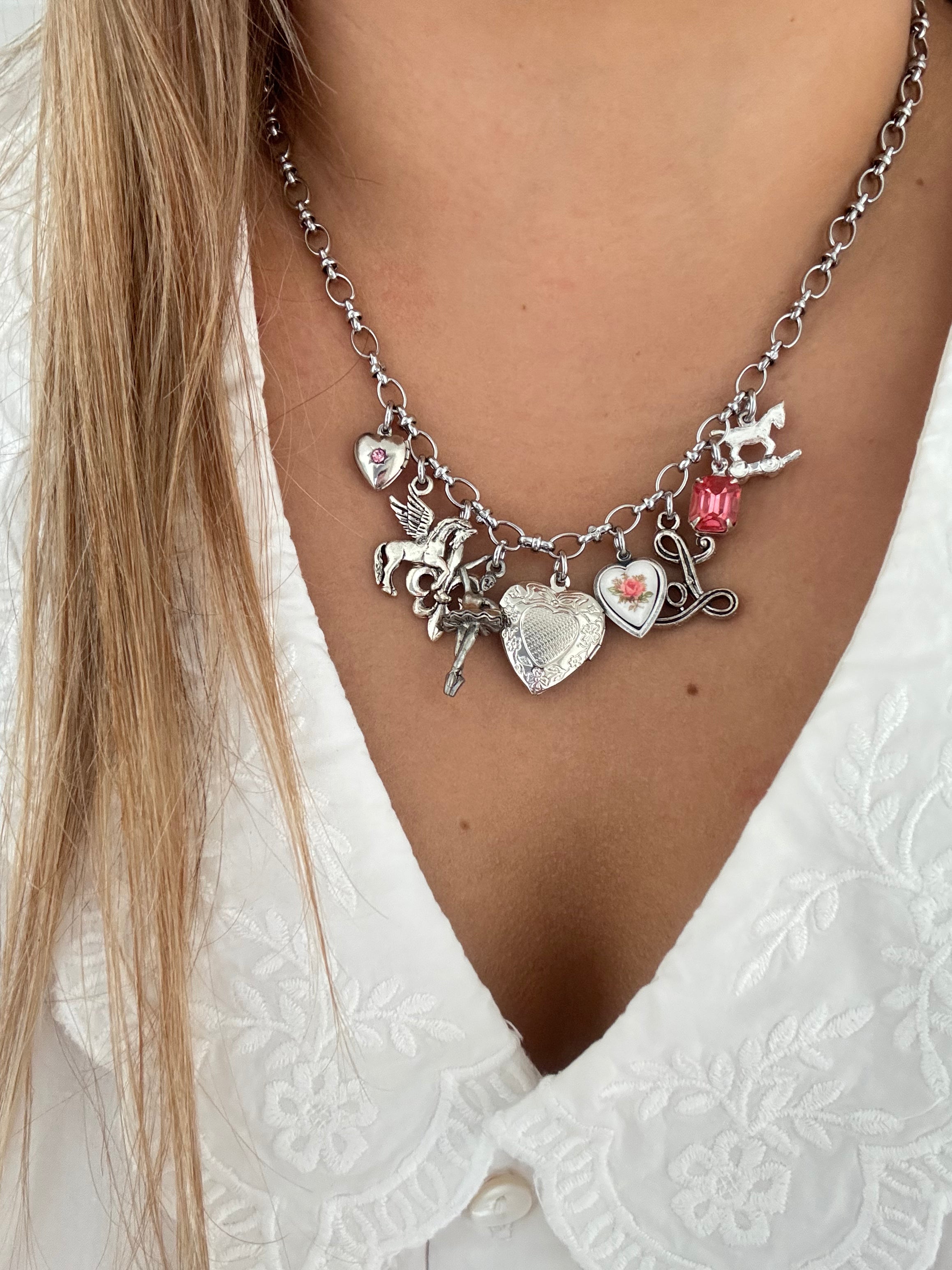 Elegant silver charm necklaces and bracelets with vintage accents.