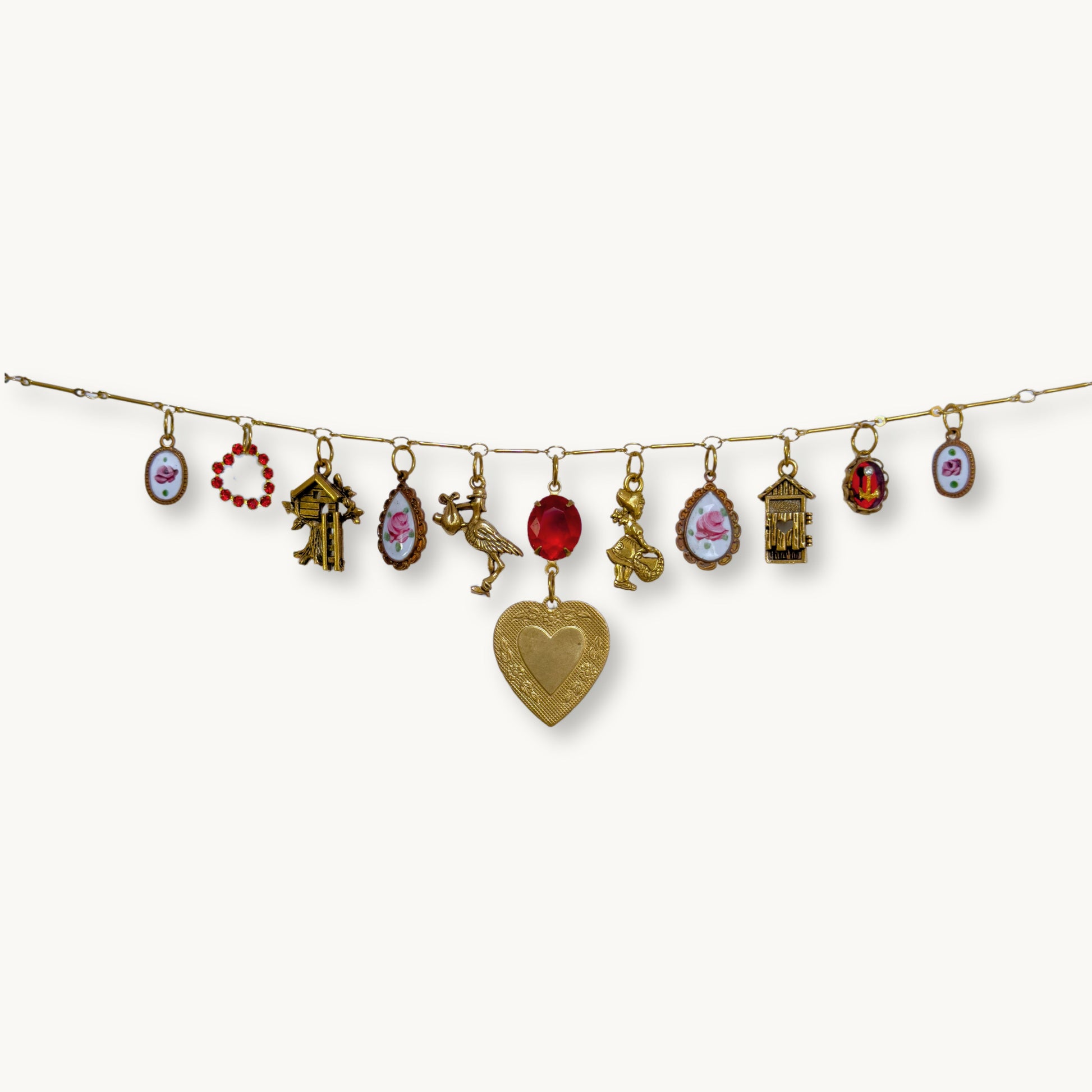 Close-up of the Imogen Necklace featuring the vintage heart pendant and red stone.