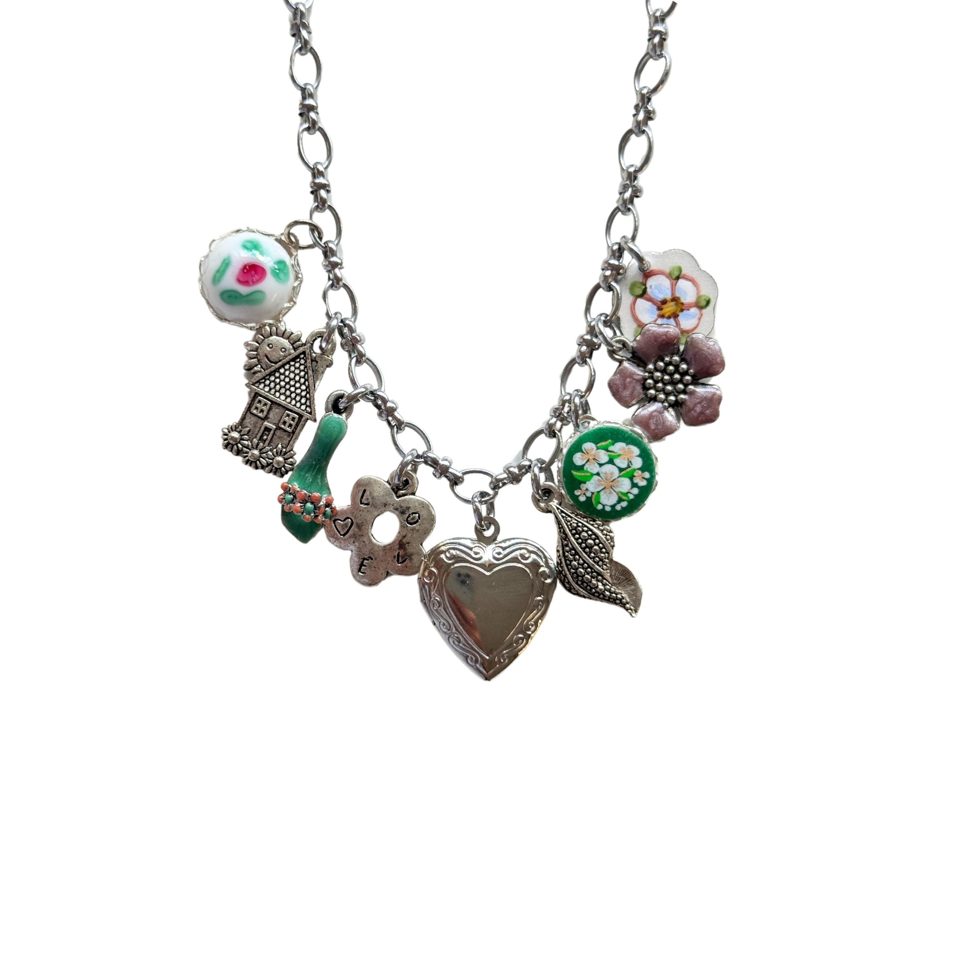 Close-up of hand-painted sandal and pink floral ceramic charm