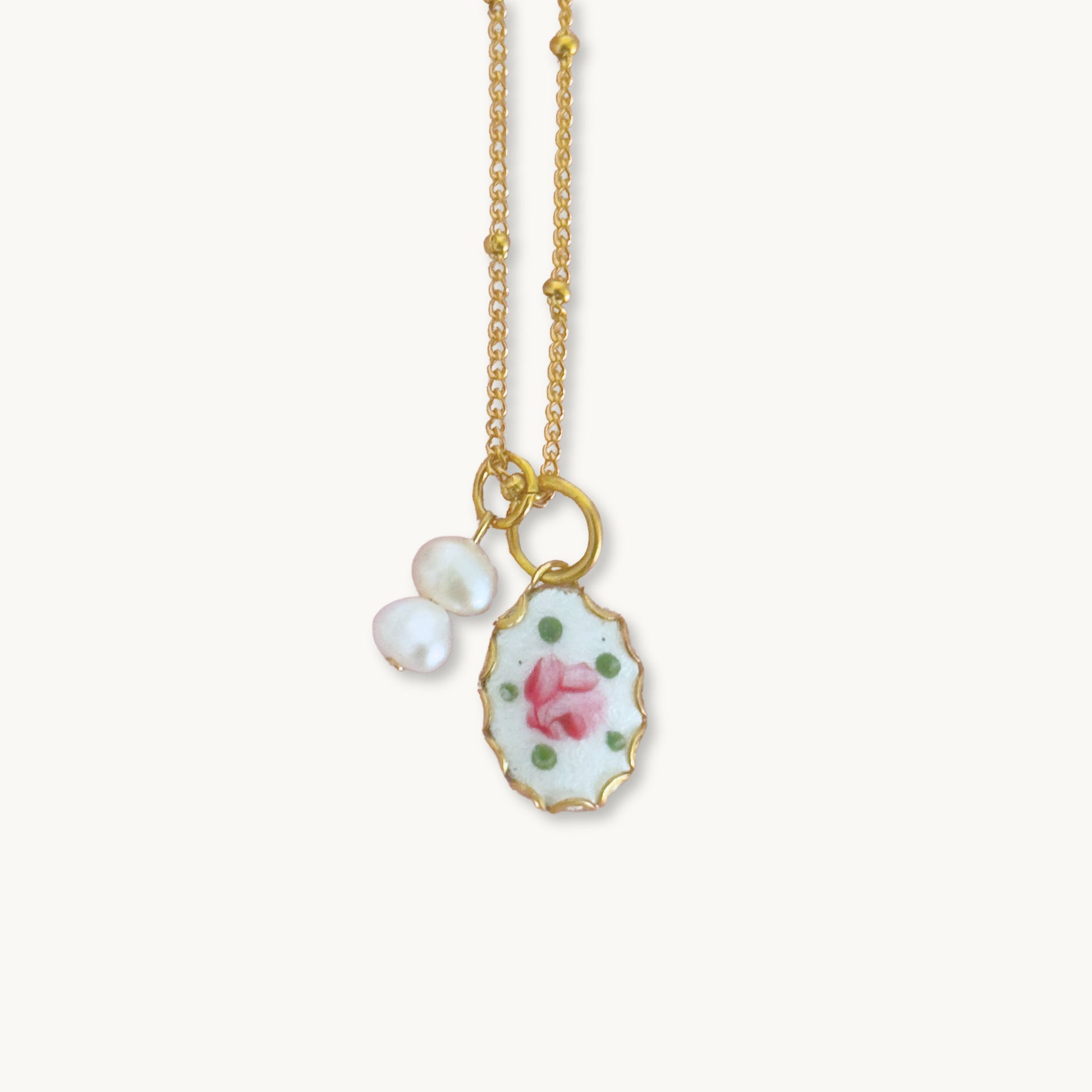 Close-up of the Muriel Necklace highlighting its delicate guilloche pendant and baroque pearl drops.