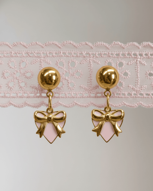 Gold and silver charm earrings with vintage-inspired details.