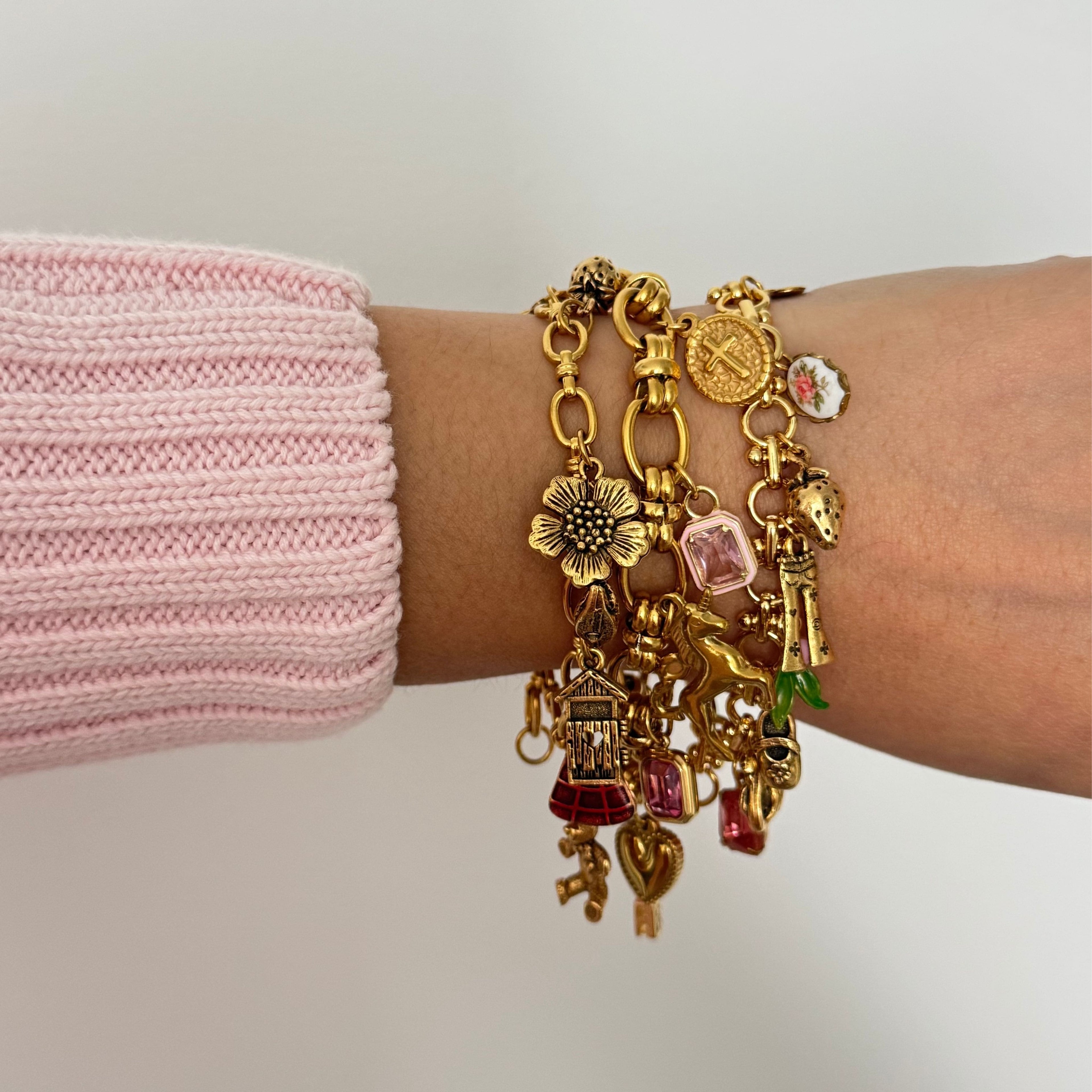 Custom gold charm bracelet featuring 8 unique modern and antique charms