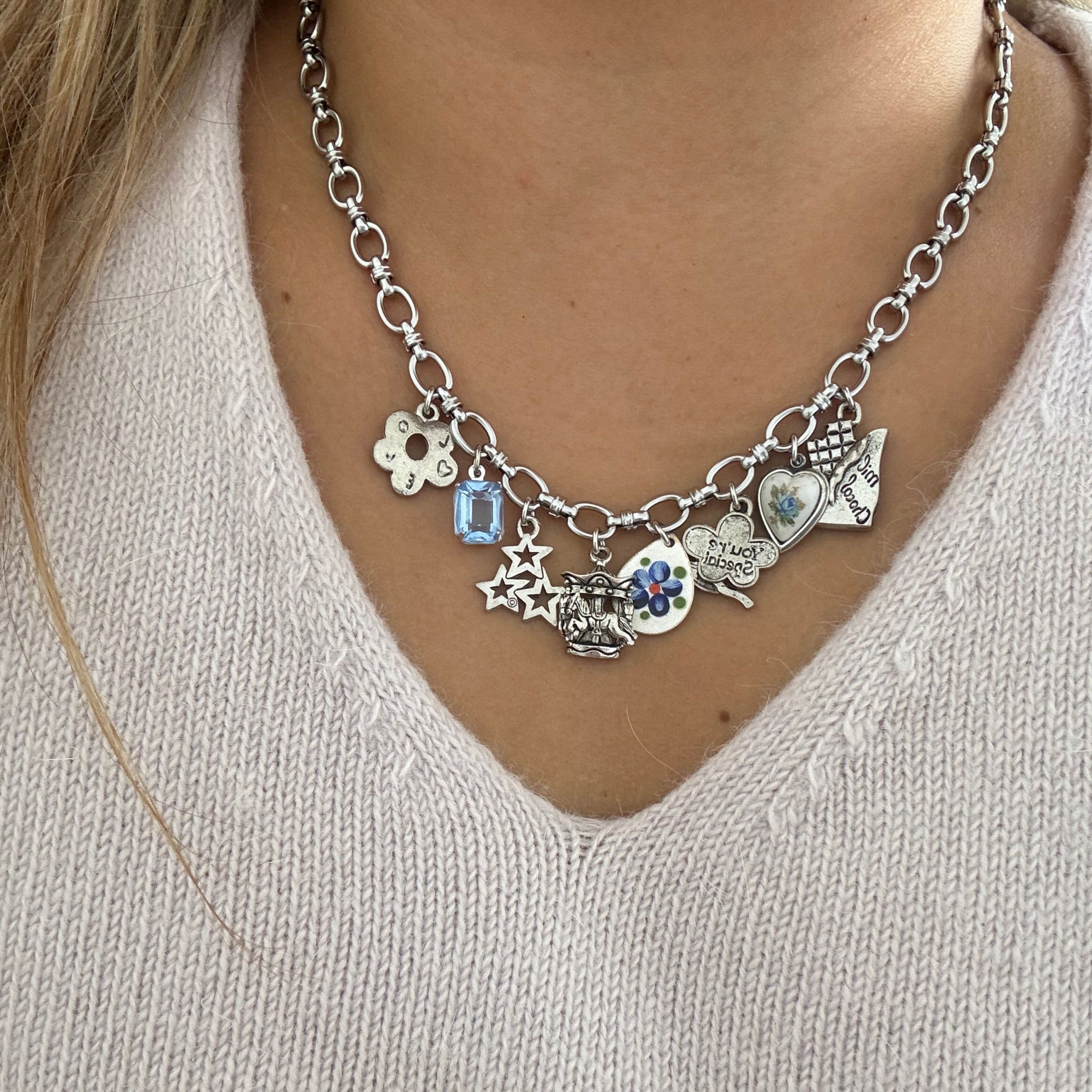 Custom silver necklace featuring 8 unique modern and antique charms