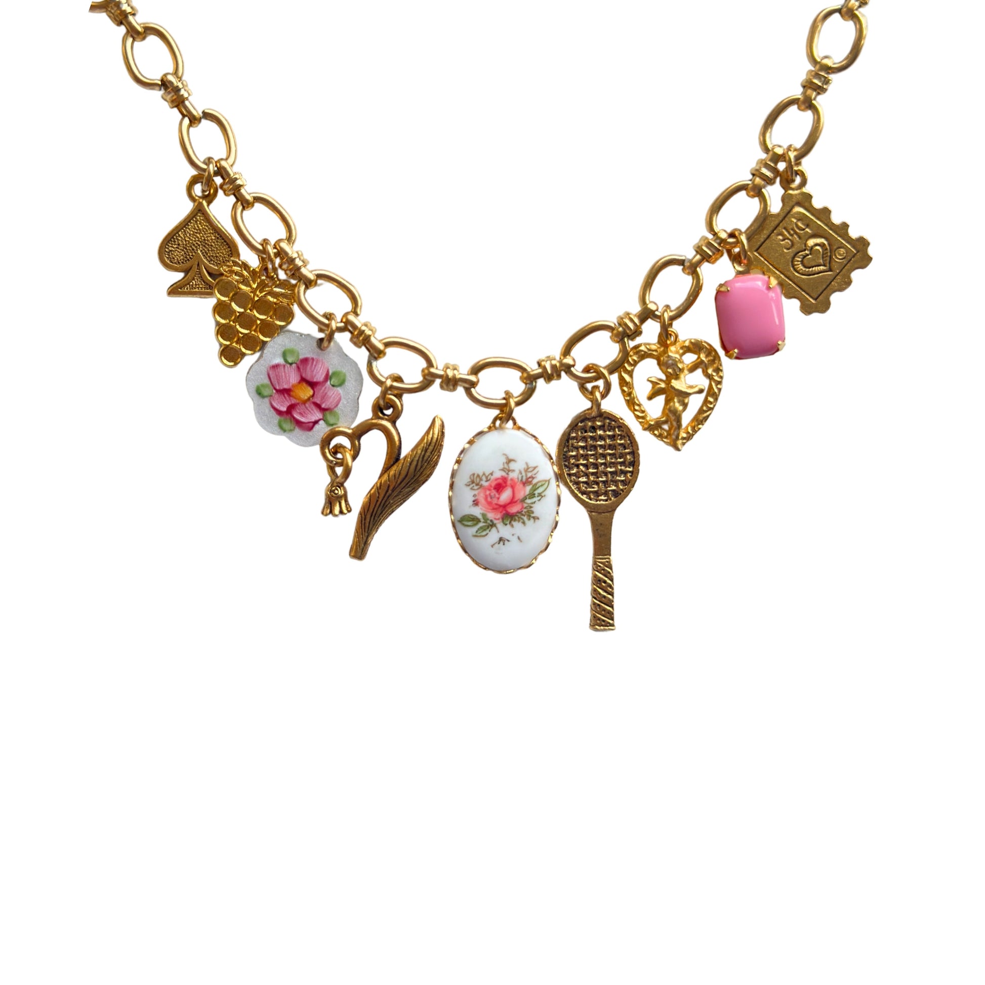 Close-up of gold-plated charms and pink stone details