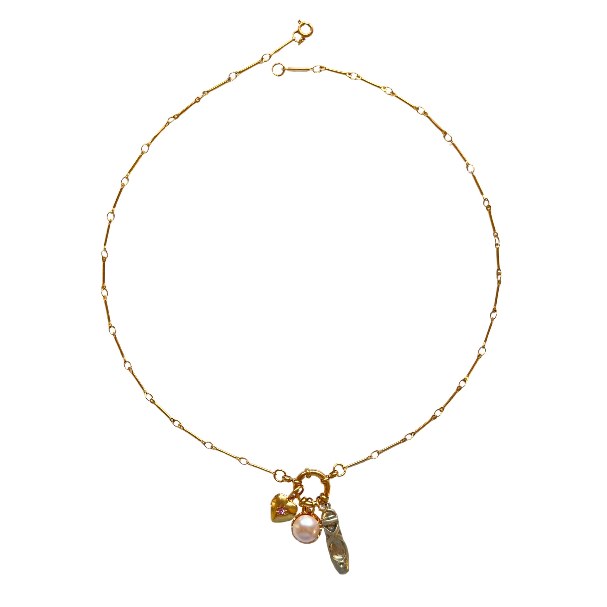Flatlay of Alegra Necklace with heart locket and pearl charm
