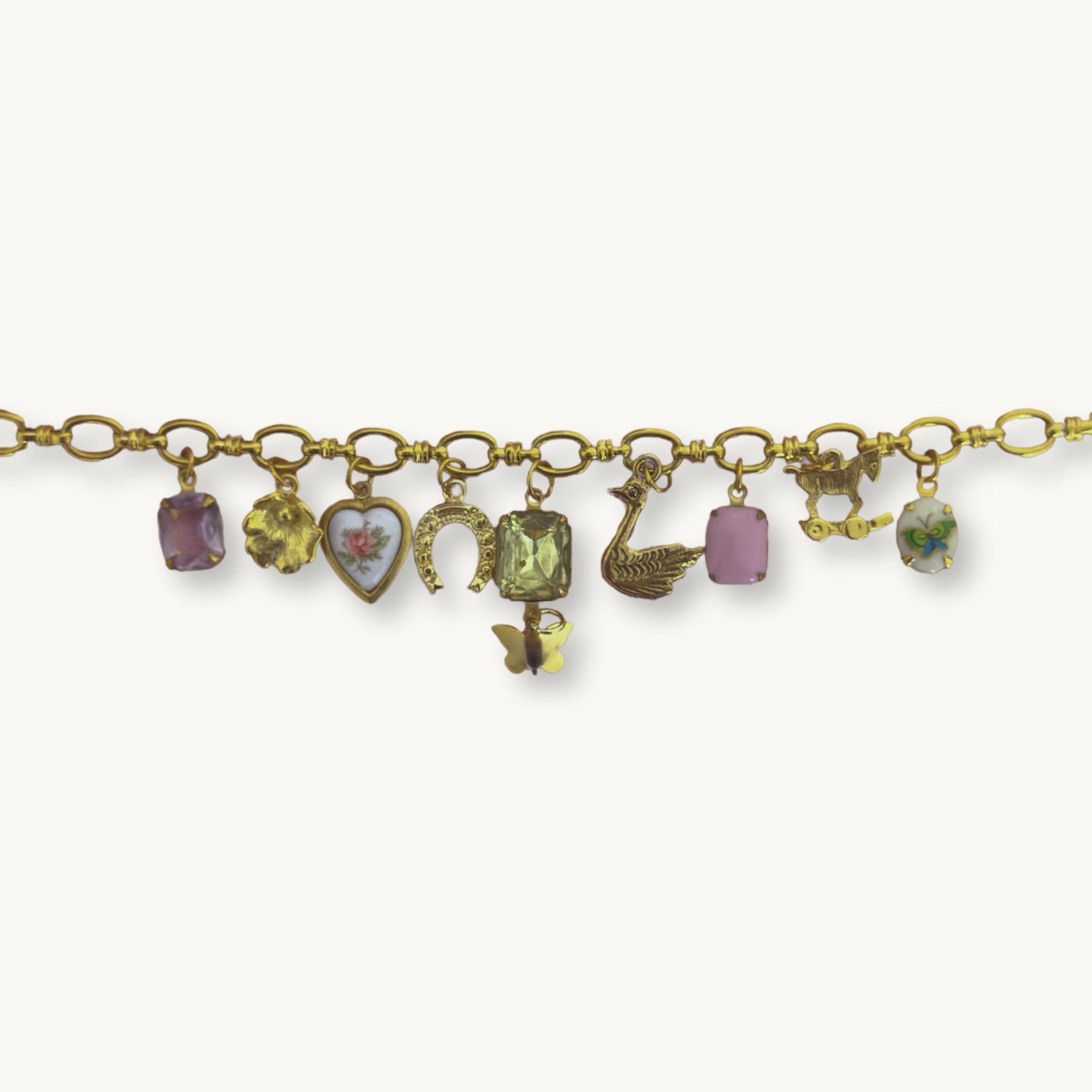 Close-up of the Althea Necklace featuring a delicate floral charm and an amethyst gemstone pendant.
