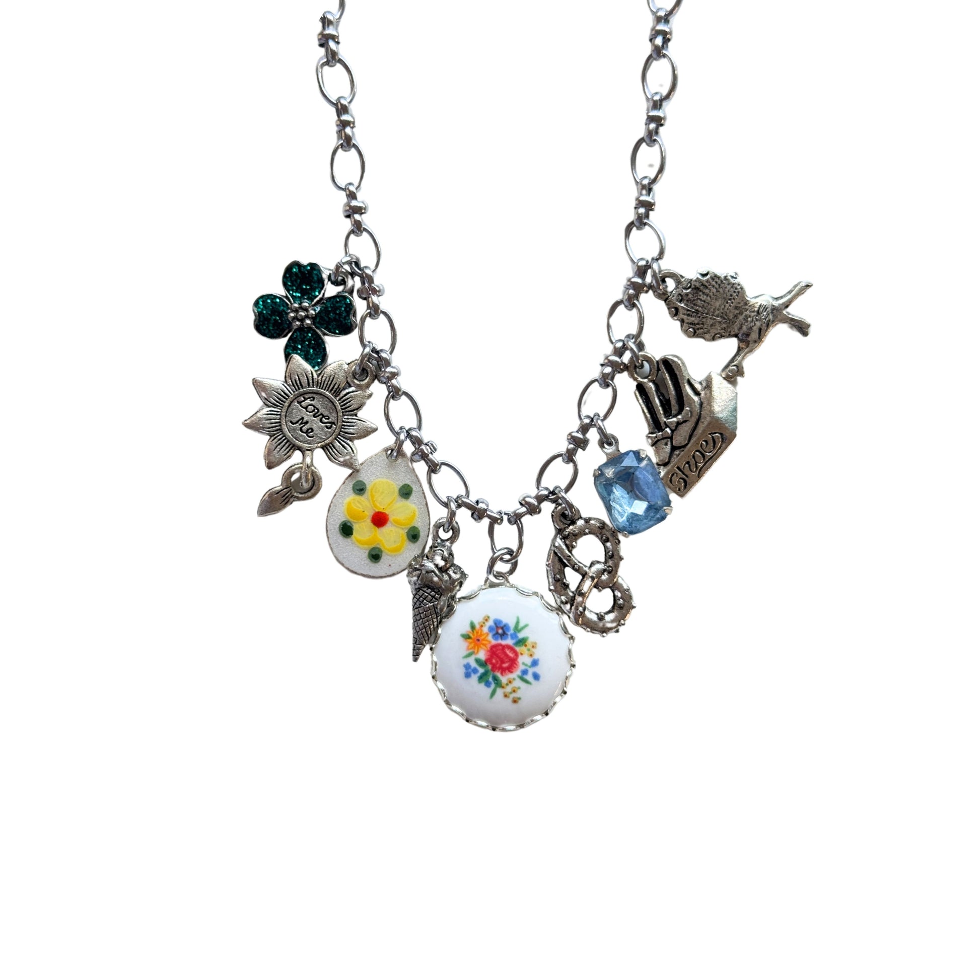 Close-up of teal glitter flower charm and yellow flower guilloche