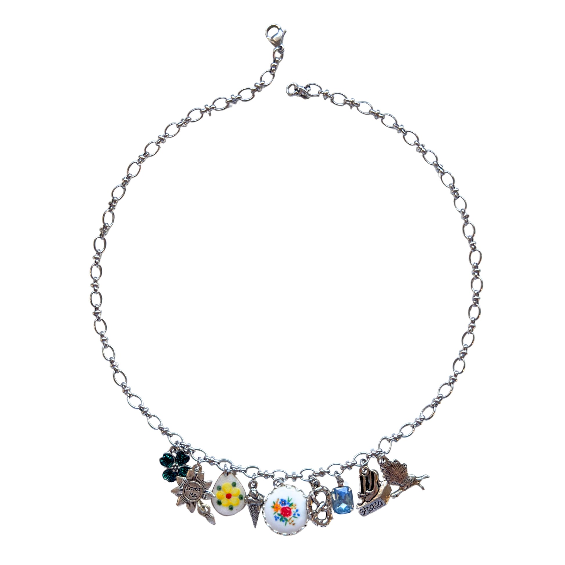 Anya Necklace flatlay showing colorful floral and playful charms