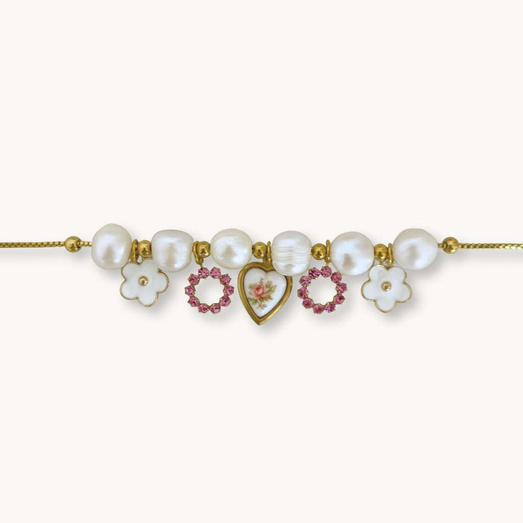 Close-up of the Aria Necklace highlighting its intricate details, including pearls, a vintage Austrian rhinestone, and a floral heart pendant.