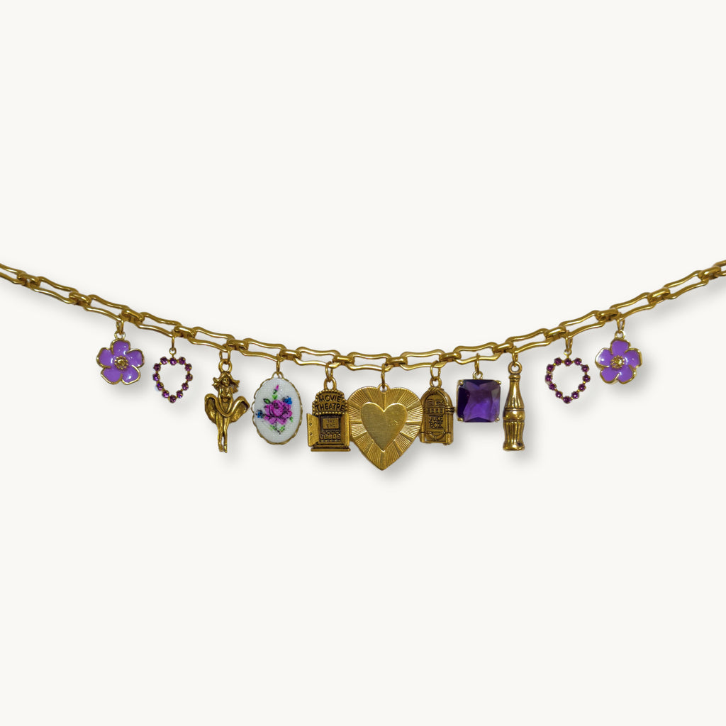 Close-up of the Audrey Necklace featuring a vintage heart pendant and charm mix.