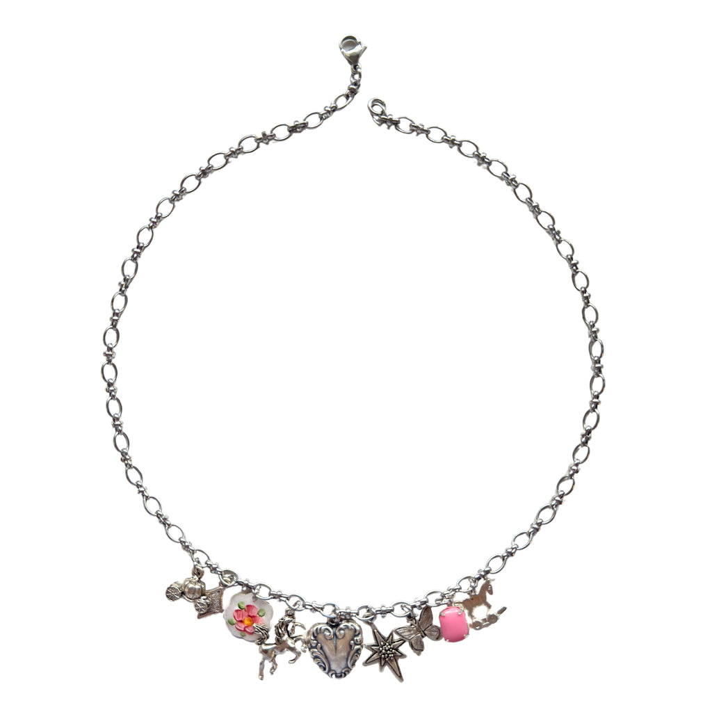 Aurora Necklace flatlay with unicorn and carriage charms