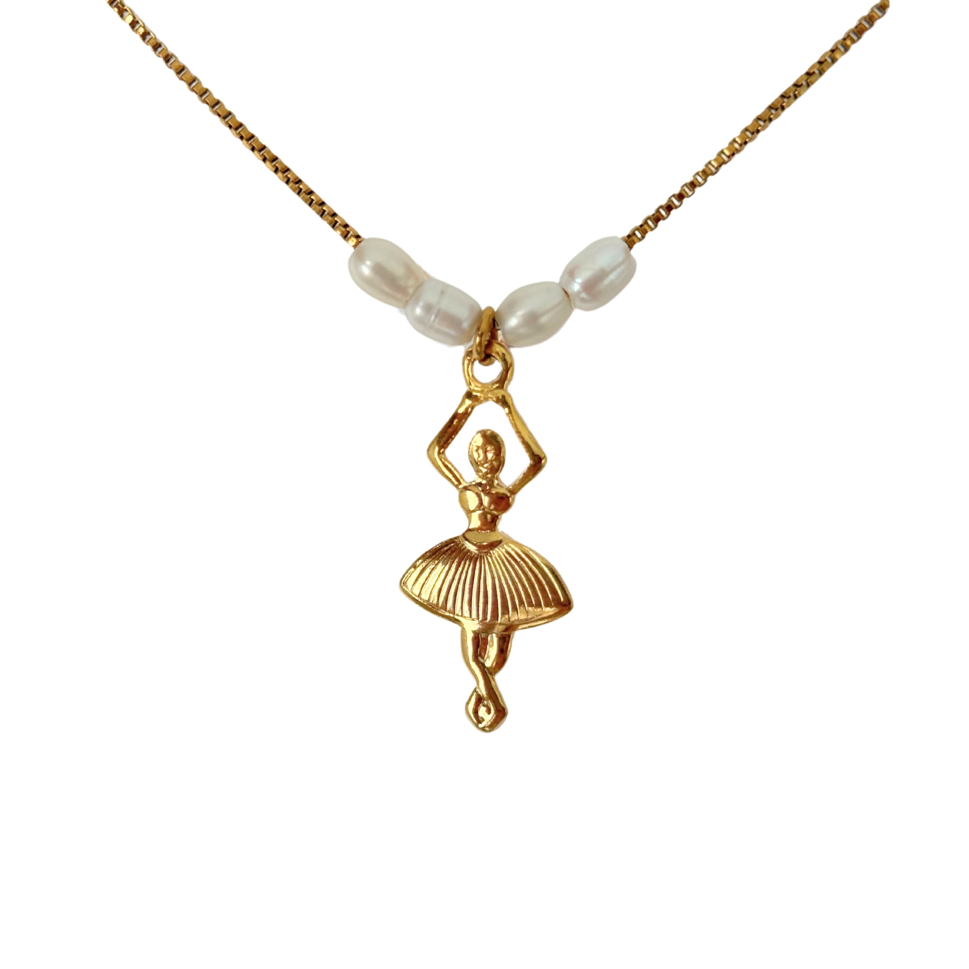 Close-up of ballerina charm and freshwater pearls