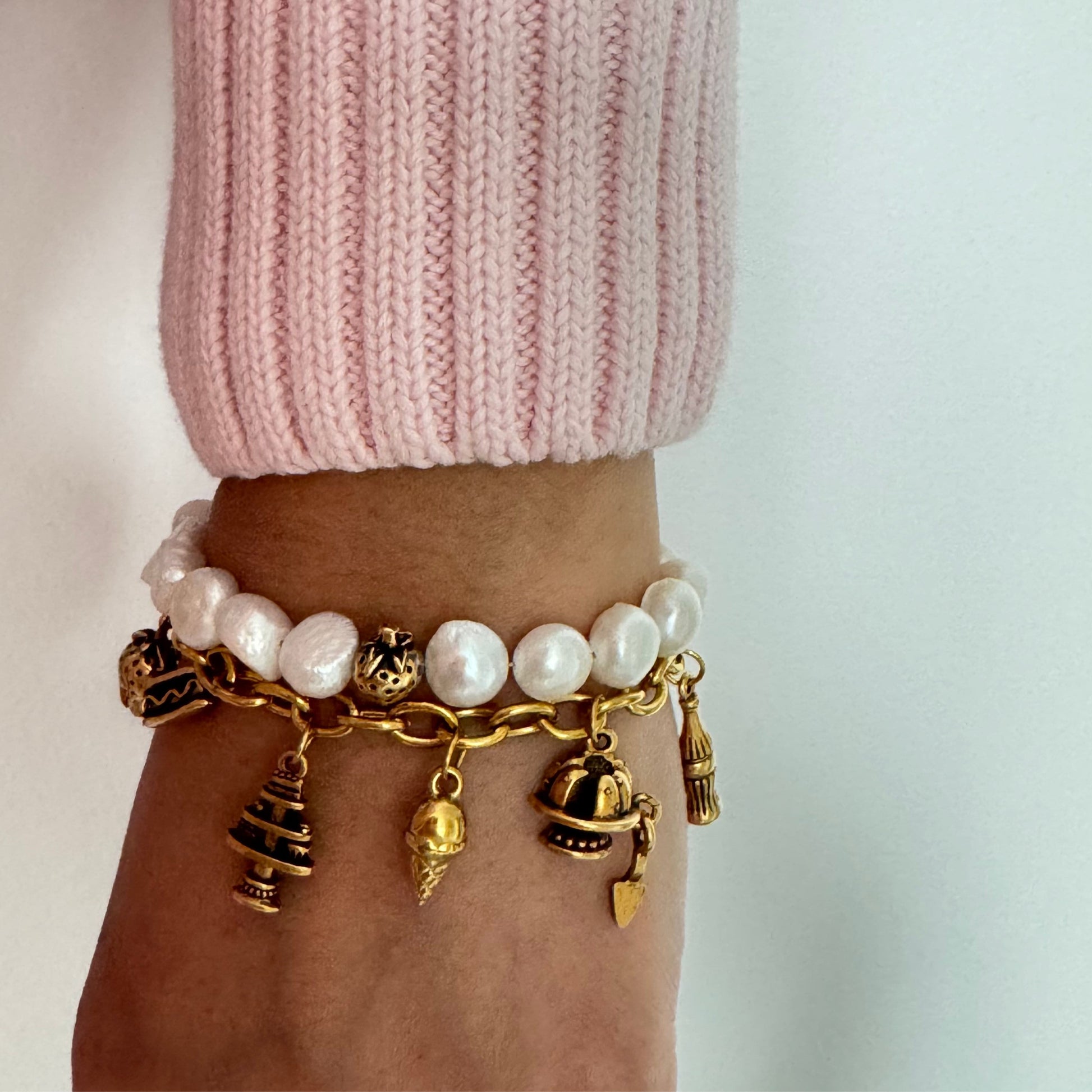 Gold-plated charm bracelet featuring cupcake, doughnut box, hotdog, and fruit basket