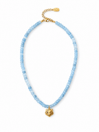 A beaded necklace featuring light blue faceted beads and a gold-tone pendant shaped like a stylized animal head, displayed on a clean white background.
