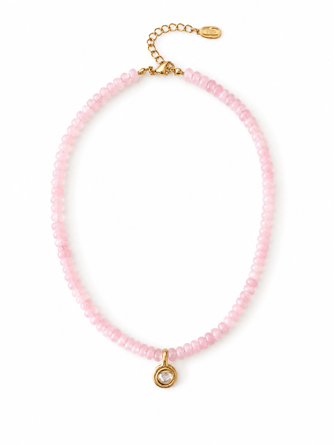 A delicate pink beaded necklace with a small gold pendant featuring a clear faceted gemstone, displayed on a clean white background.