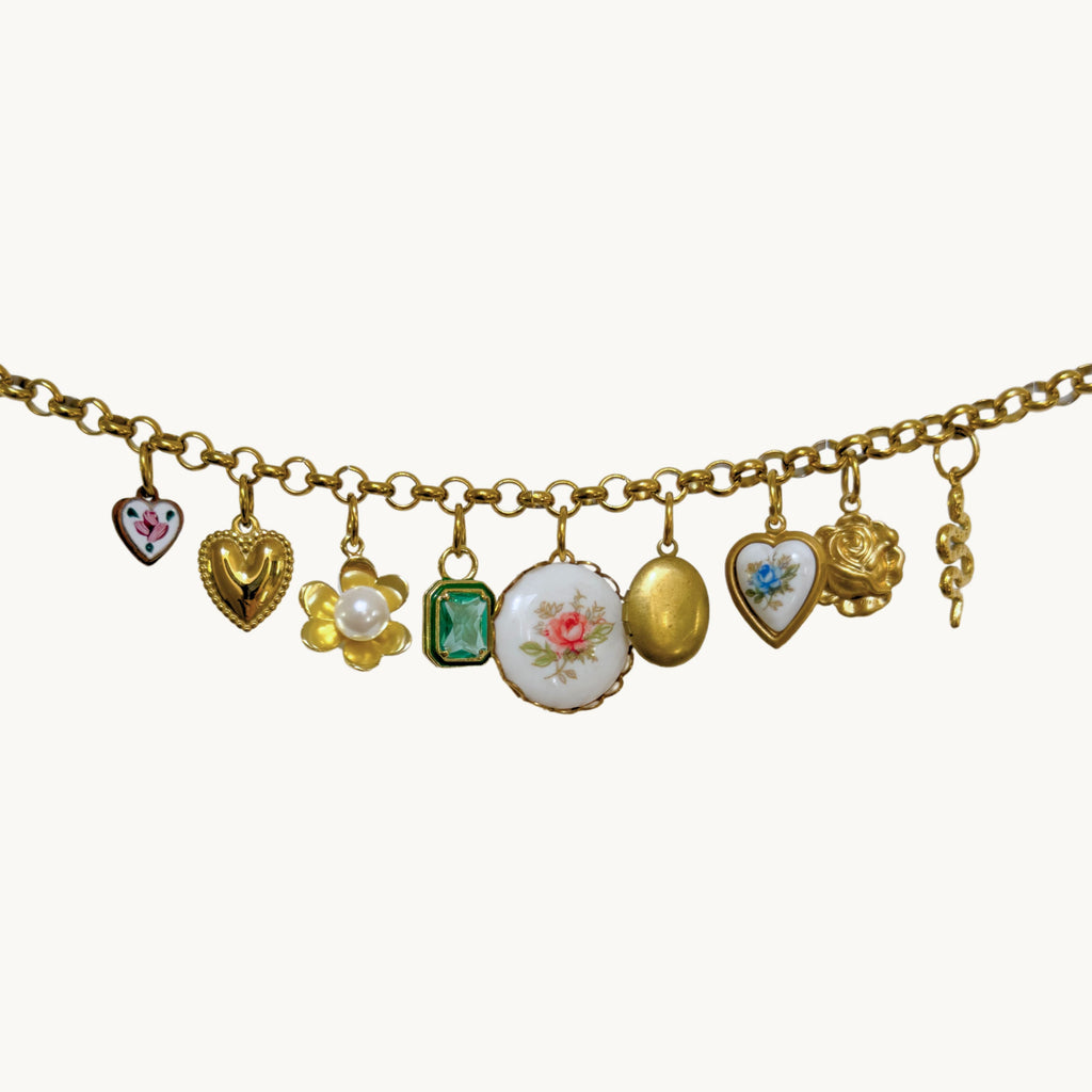 Close-up of the Blythe Necklace showcasing its vintage charms and intricate details.