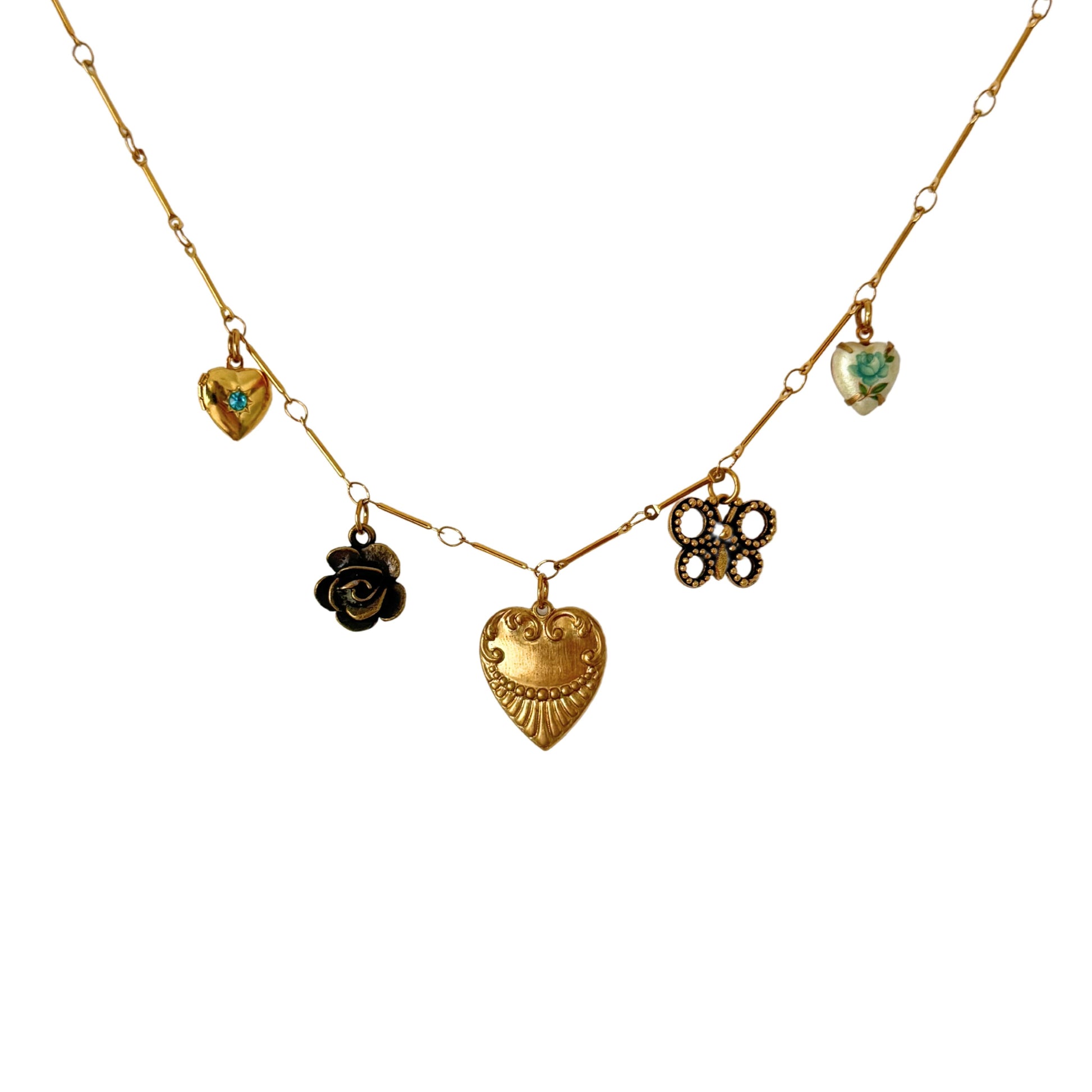 Close-up of Carina necklace with butterfly and blue rose charm