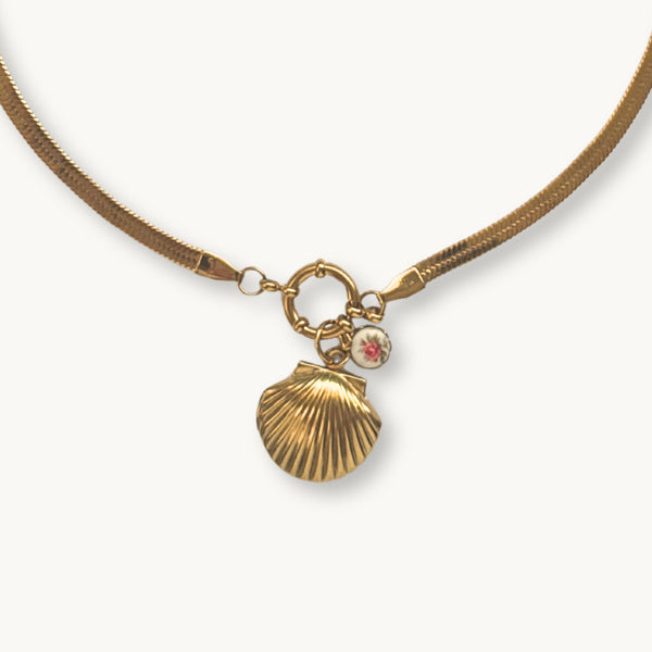Close-up of the CiCi Necklace showcasing its chunky gold snake chain and shell locket.