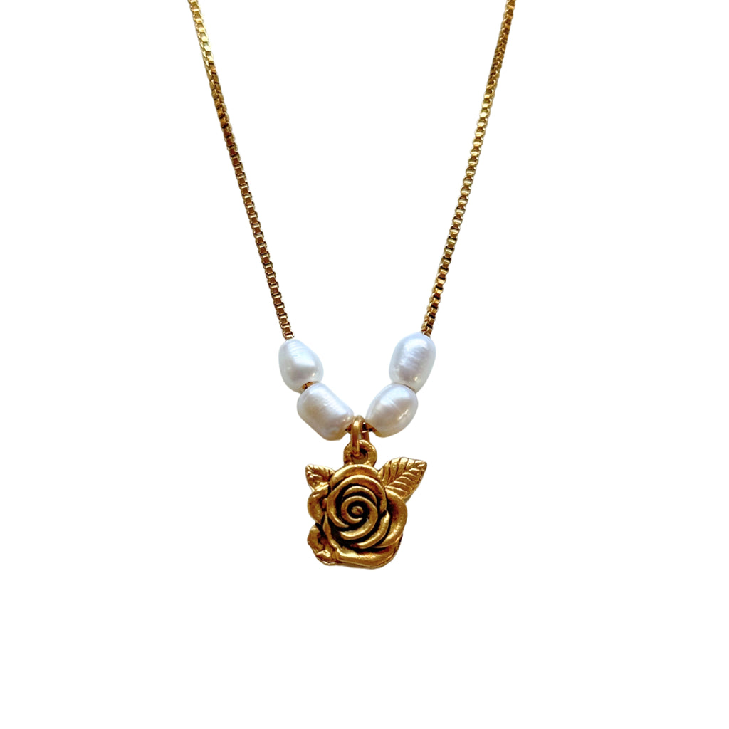 Close-up of shabby English rose pendant and freshwater pearls