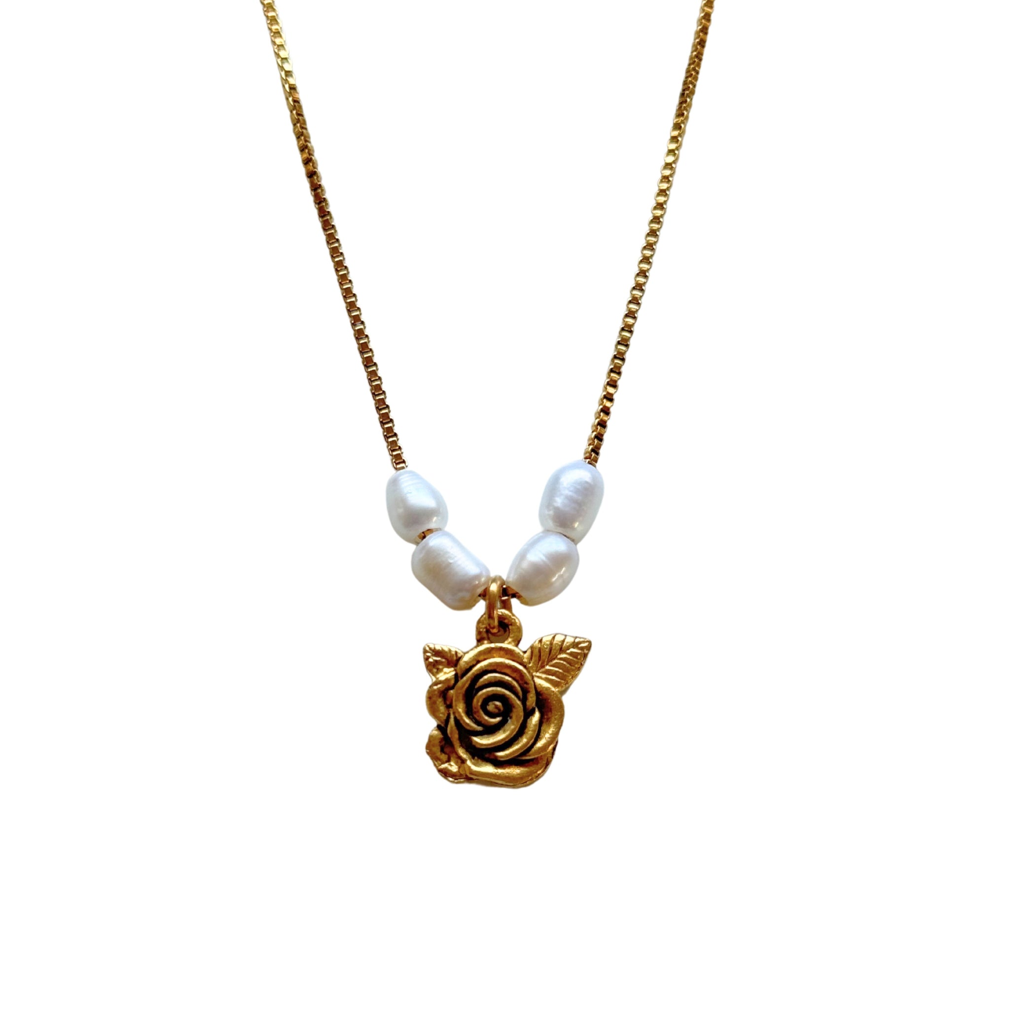 Close-up of shabby English rose pendant and freshwater pearls