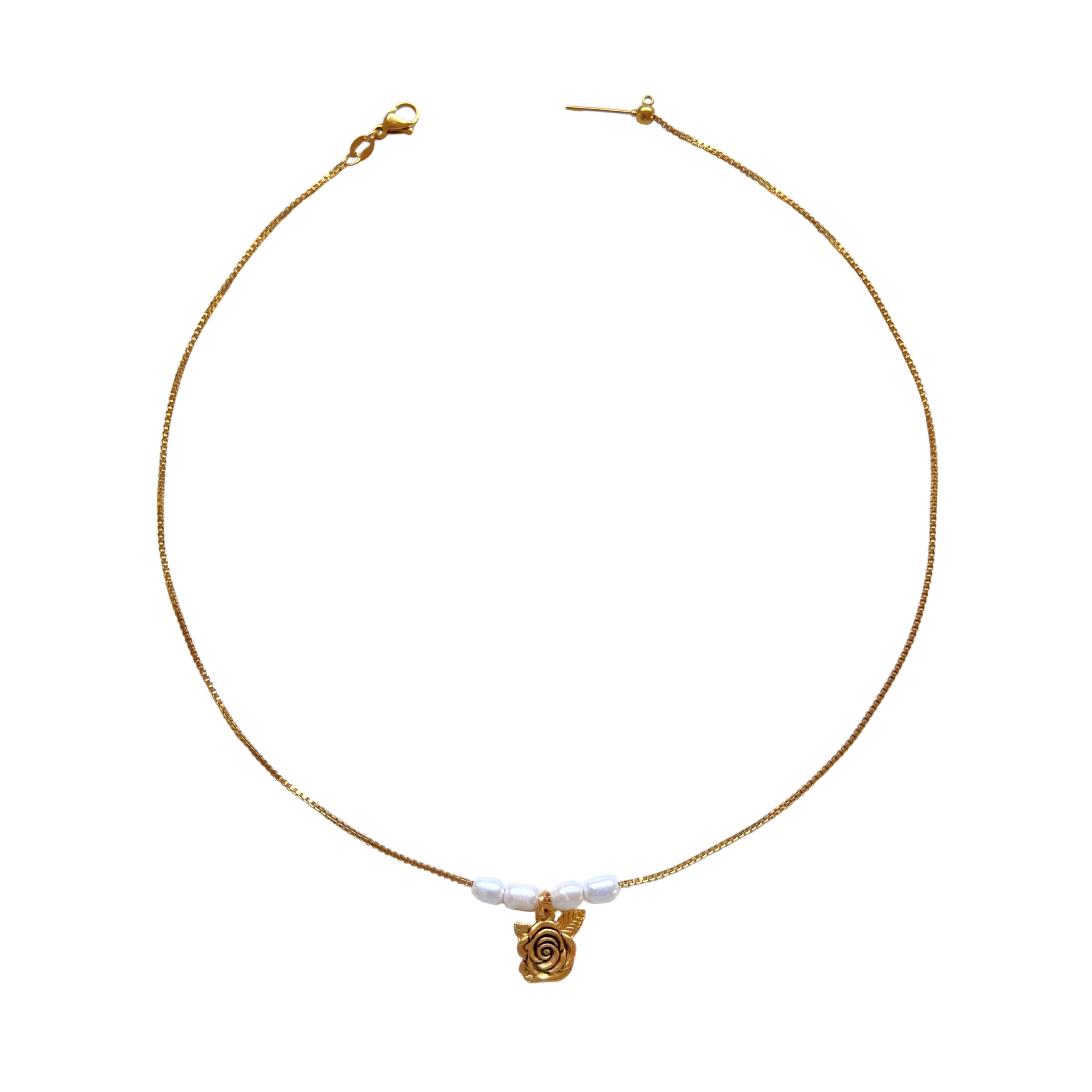 Clara Necklace flatlay with rose charm and pearls