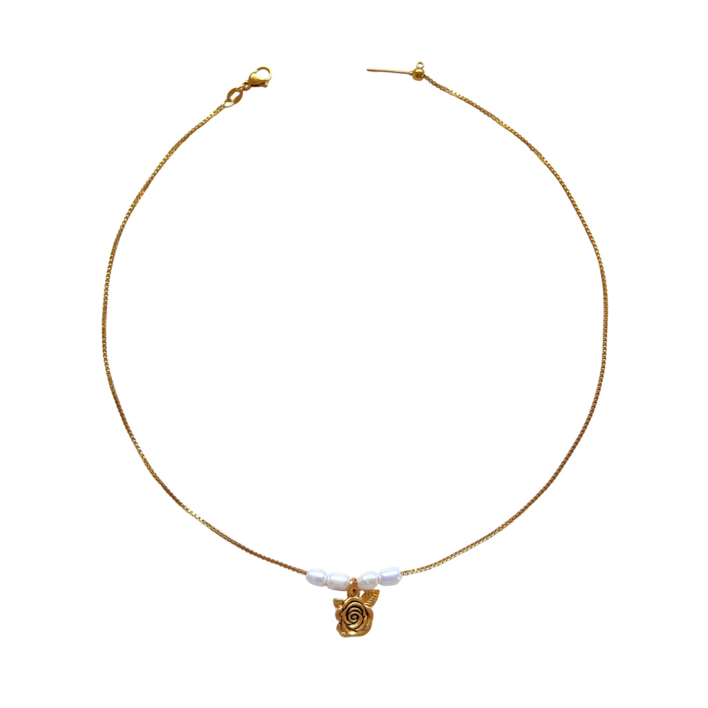 Clara Necklace flatlay with rose charm and pearls