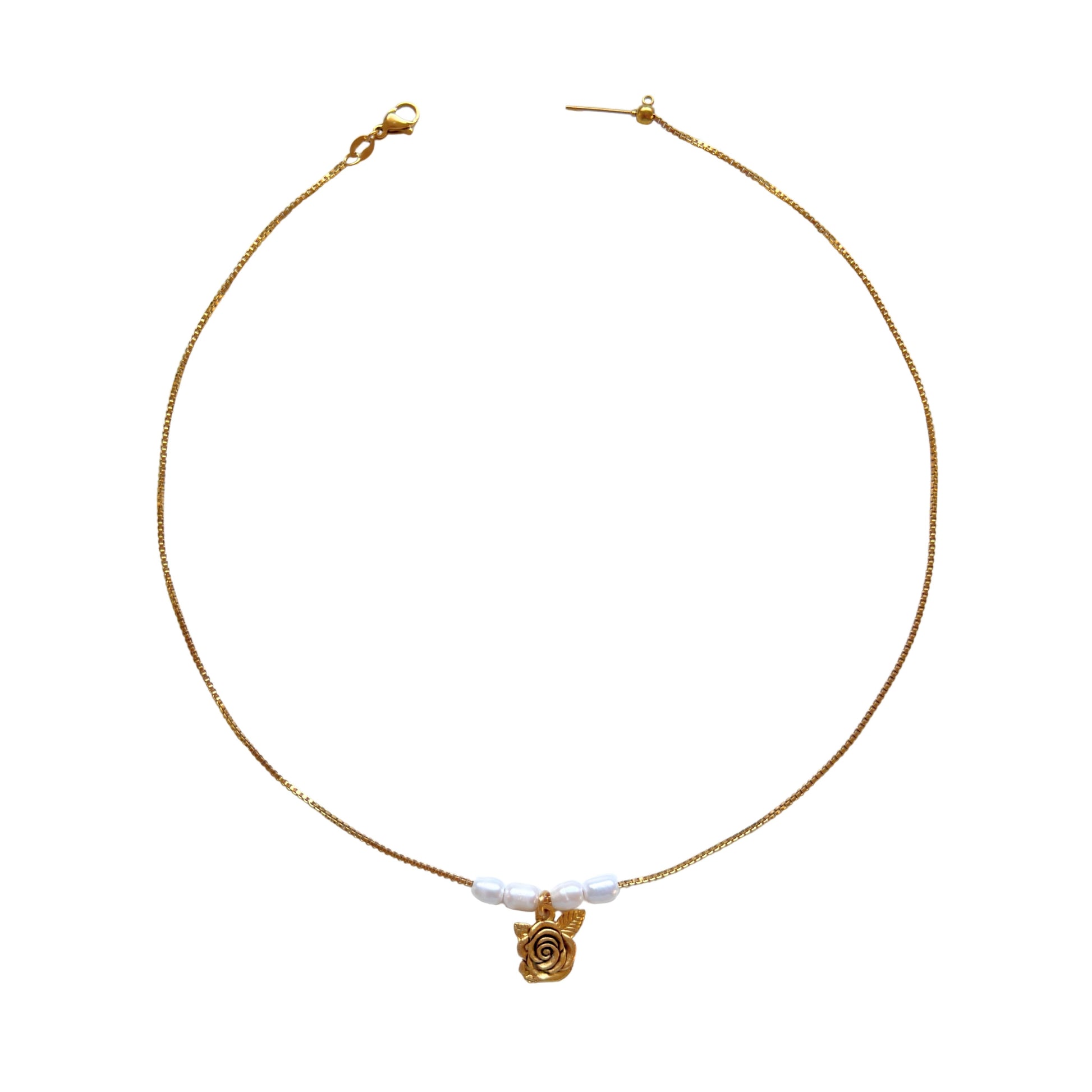 Clara Necklace flatlay with rose charm and pearls