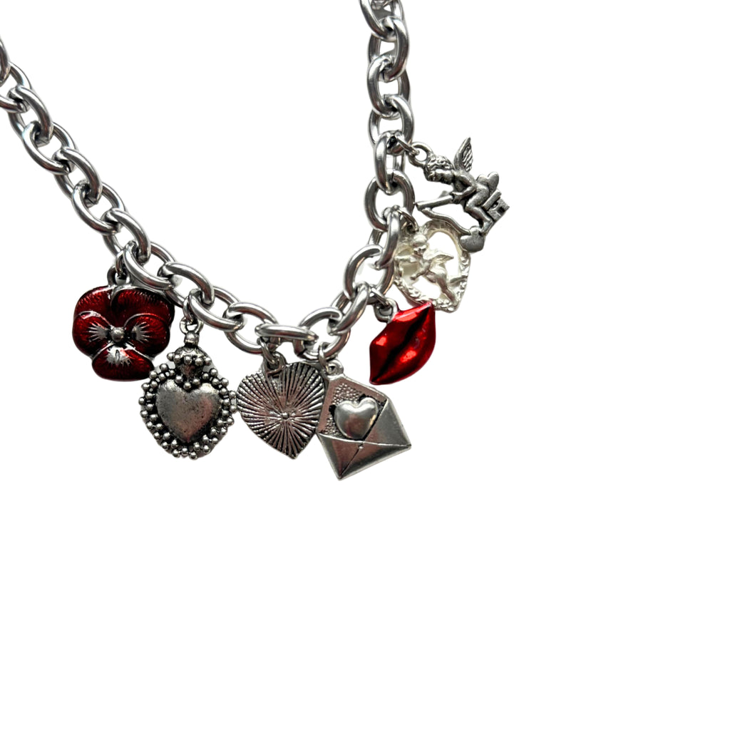 Cressida Bracelet flatlay showing antique pewter and silver-plated charms