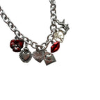 Cressida Bracelet flatlay showing antique pewter and silver-plated charms