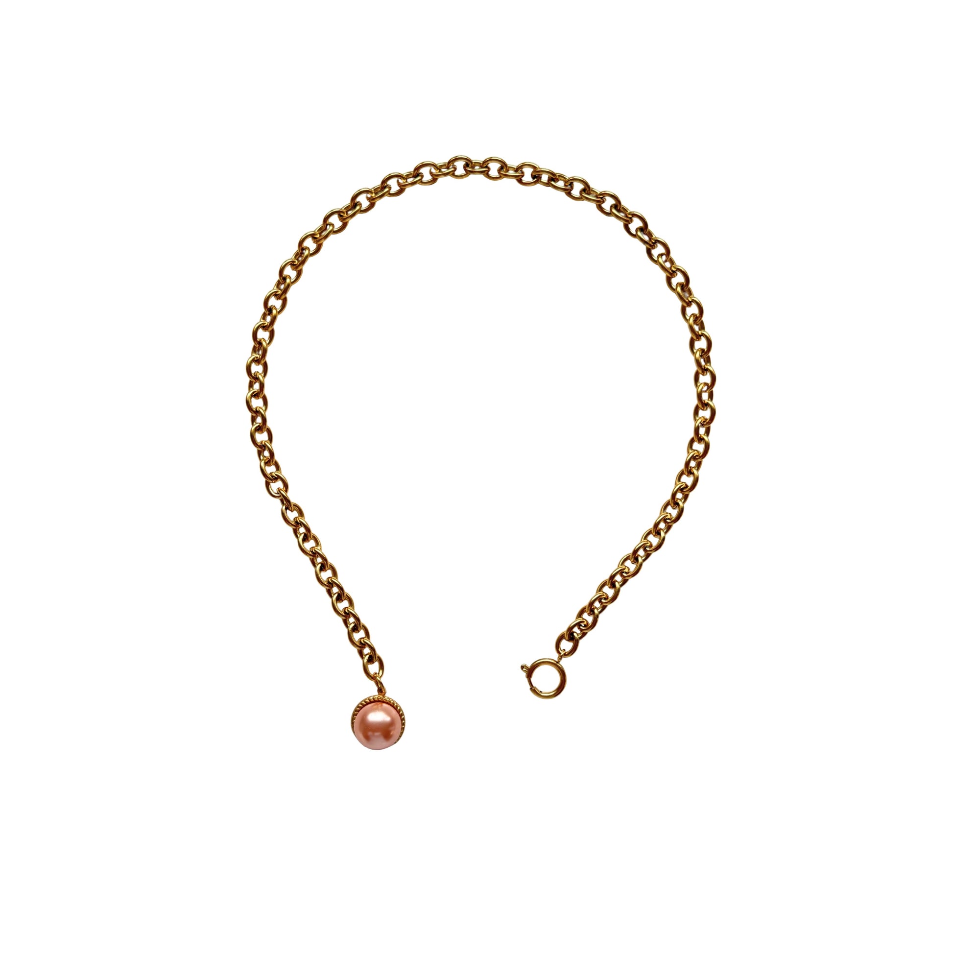 Close-up of Esmeralda’s pearl pendant and chunky spring lock