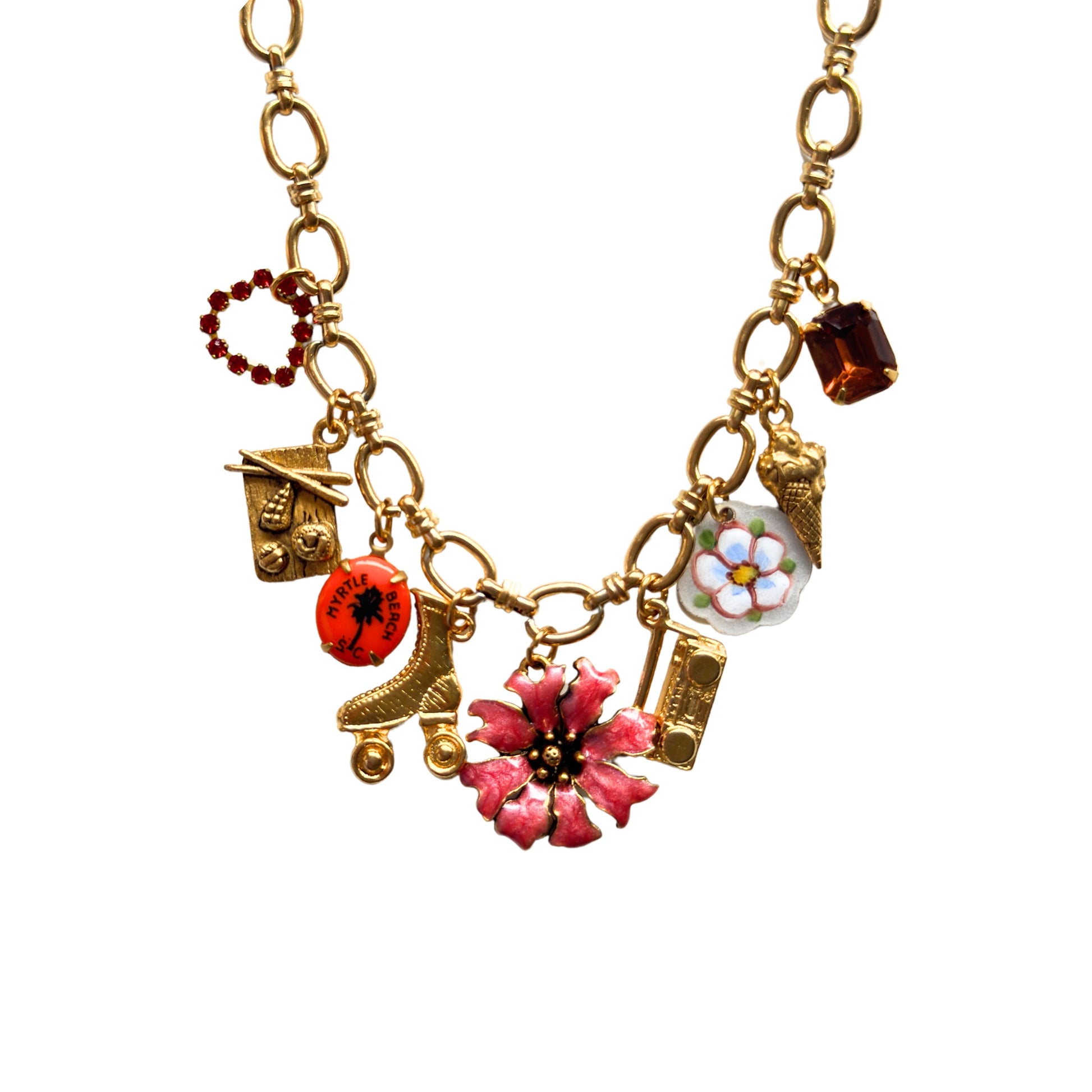 Close-up of sushi, roller skate, and boombox gold charms