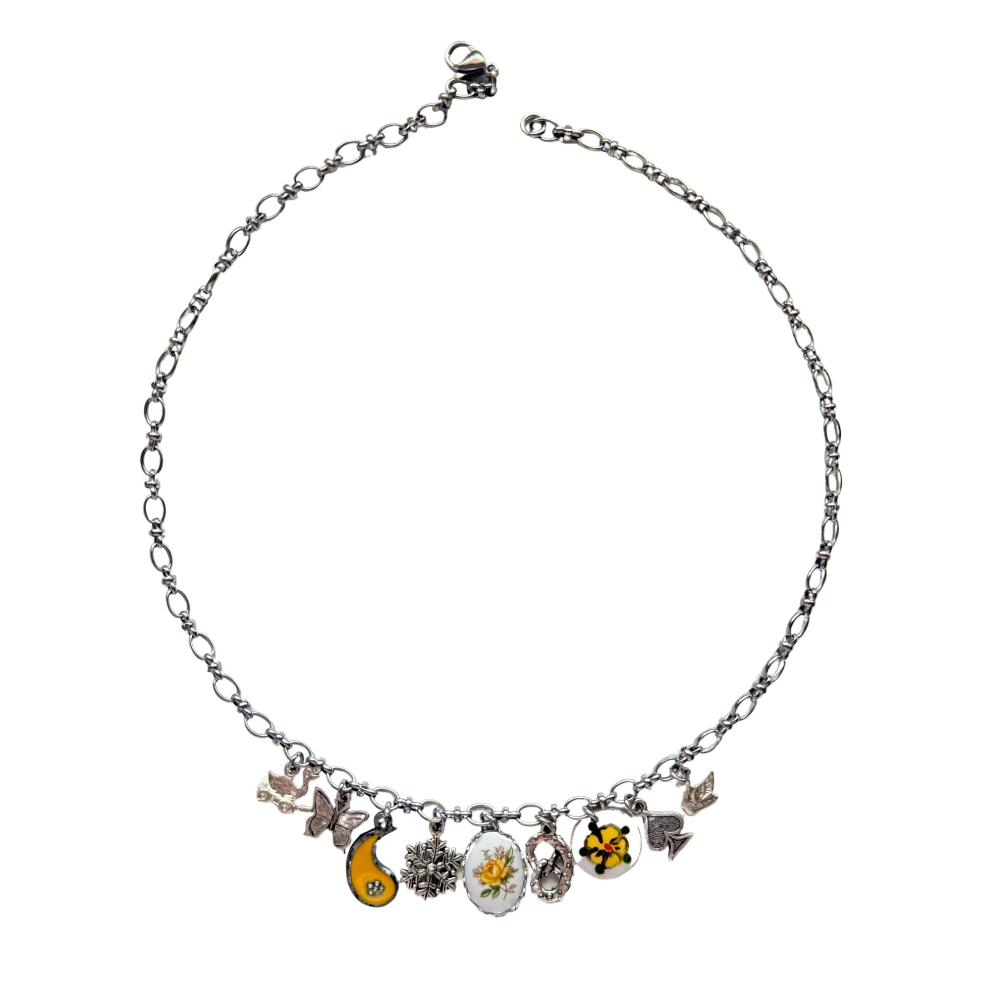 Greta Necklace flatlay with swan and floral charms