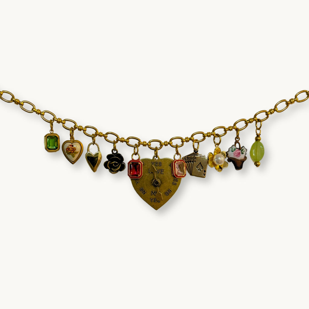Close-up of the Harriet Necklace featuring a spinner heart pendant and vintage charms.