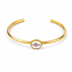 A polished gold-tone open cuff bracelet featuring a central oval bezel-set floral charm with pink and green enamel details, shown on a clean white background.