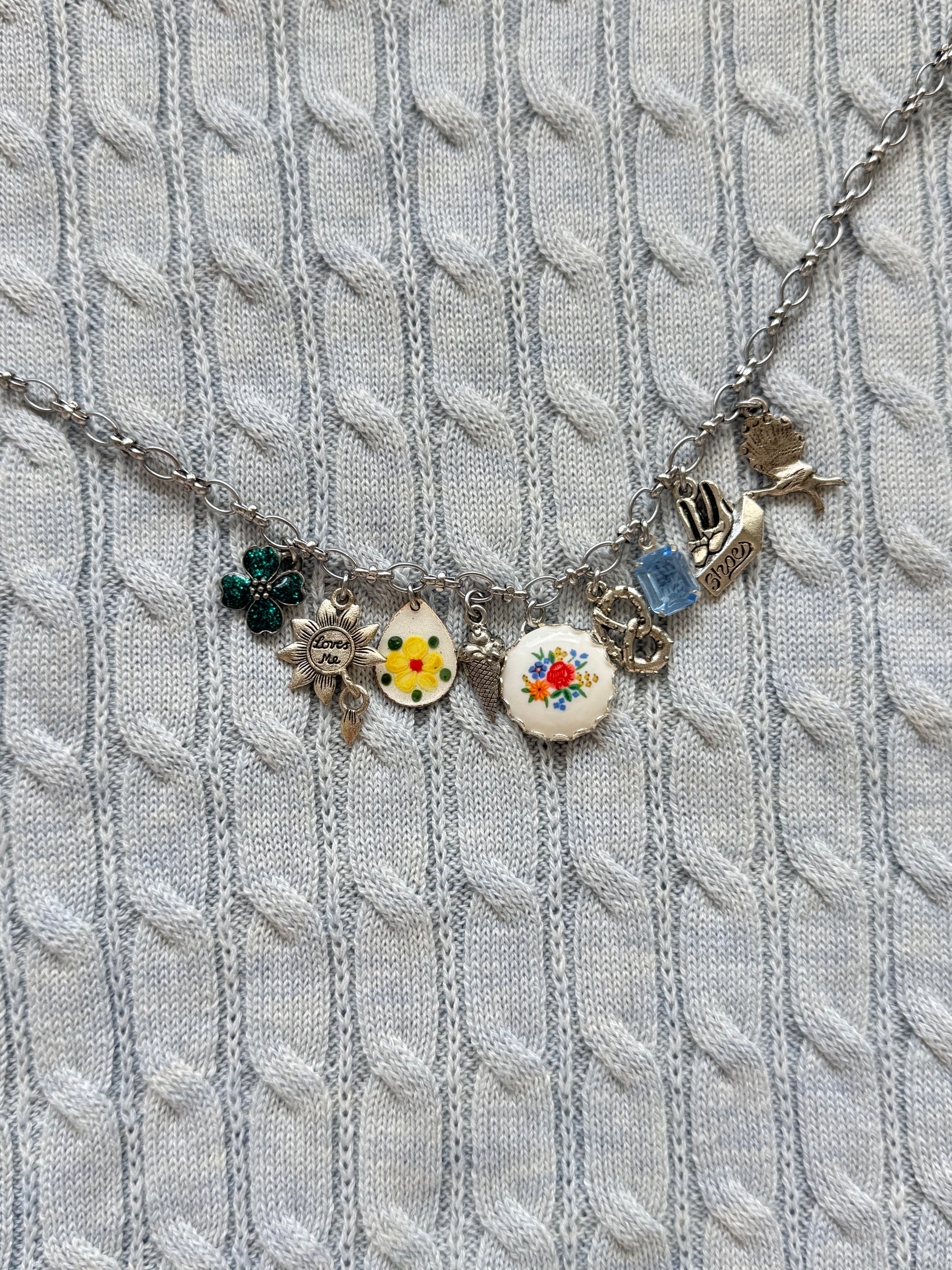 White gold-plated charm necklace with ice cream and pretzel accents