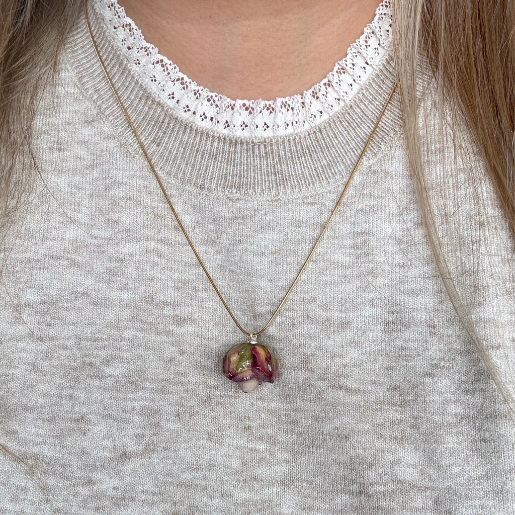 Model wearing the Rose Necklace in soft lighting