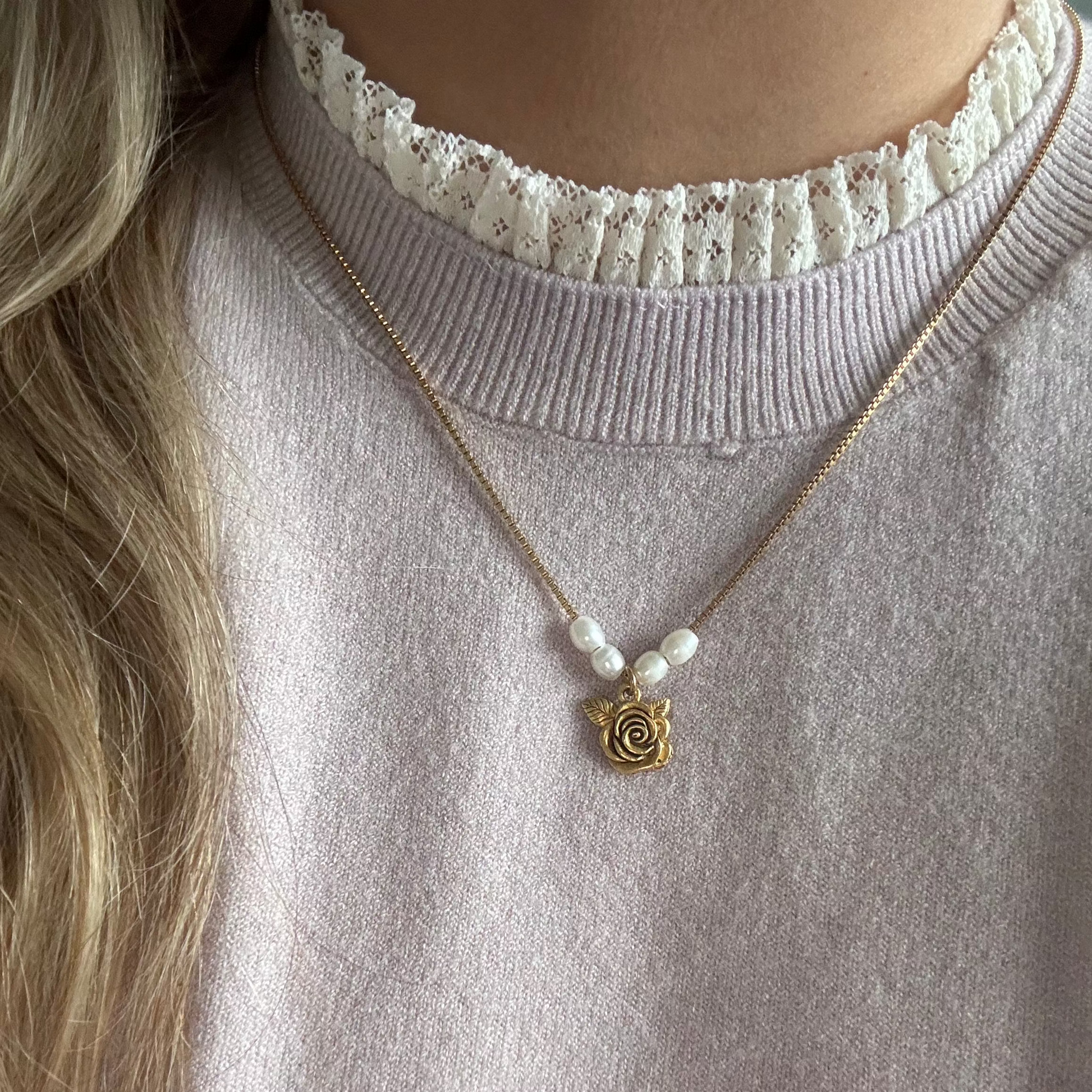 Model wearing the Clara Necklace — a dainty gold box chain with freshwater pearls and a shabby English rose pendant, styled for a soft, romantic vintage look.