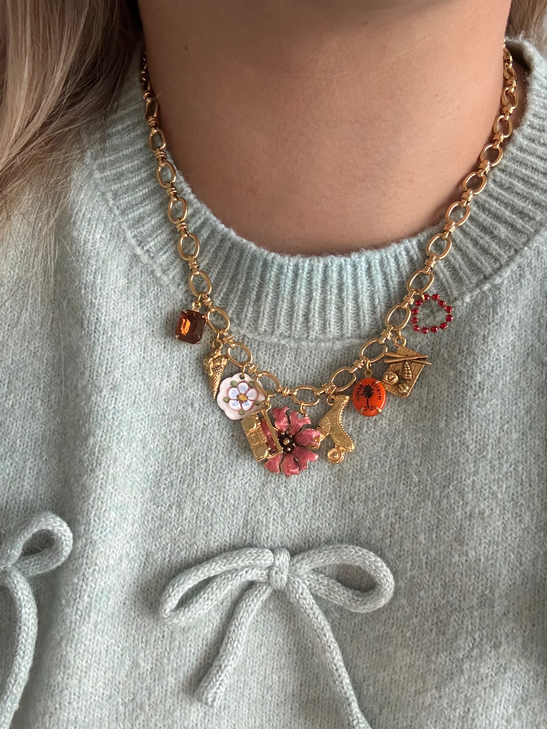 Custom gold charm necklace featuring 8 unique modern and antique charms