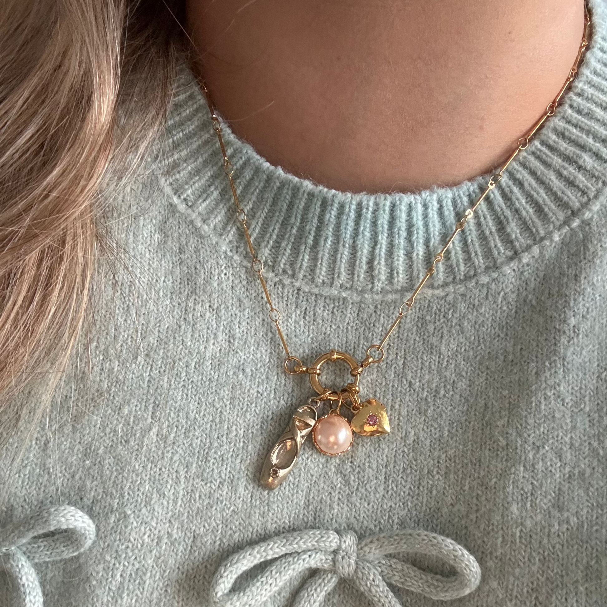 Model wearing Alegra Necklace with ballerina slipper and heart locket charms