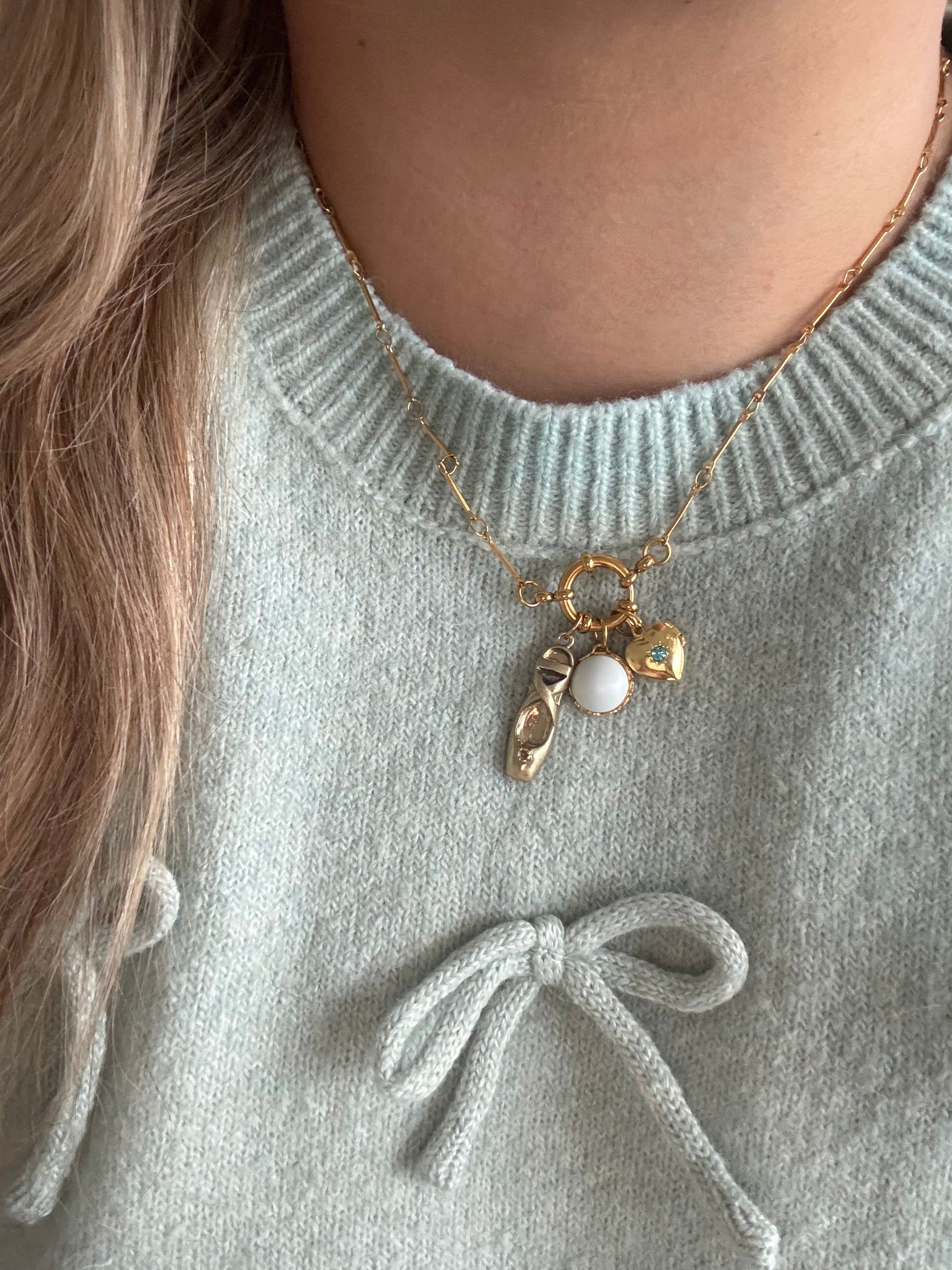 Model wearing Sylvie Necklace with ballerina slipper and blue pearl charm