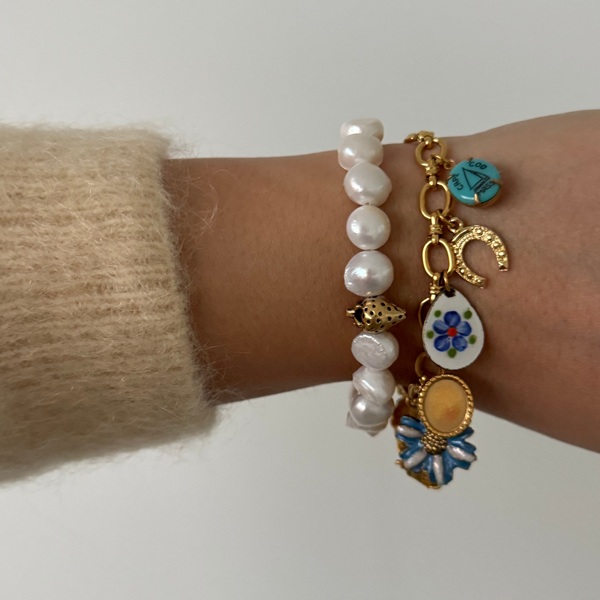 Model wearing Kyra Bracelet with pearl bracelet