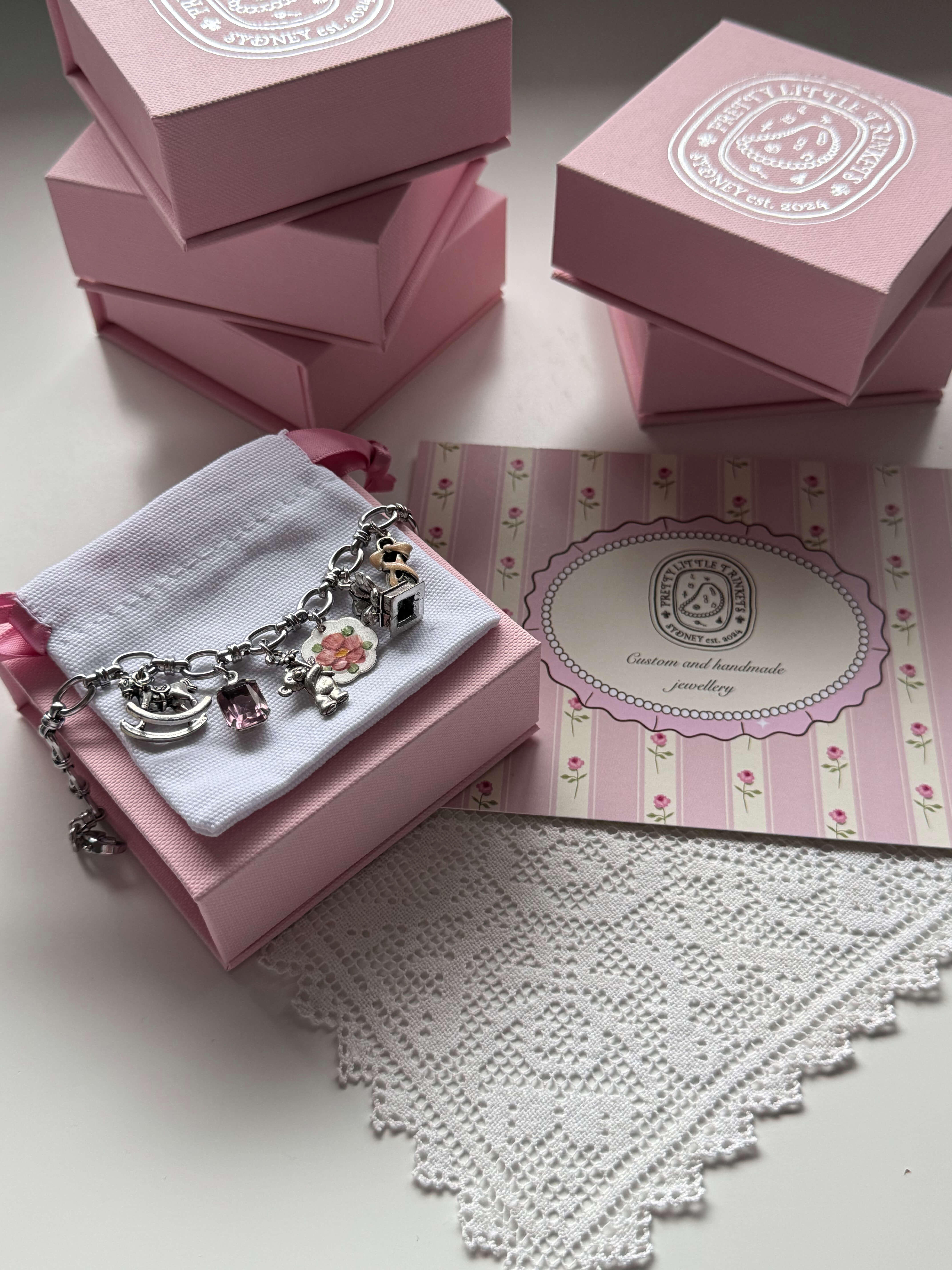 Pink jewelry packaging box with ribbon – perfect for gifting Pretty Little Trinkets pieces.