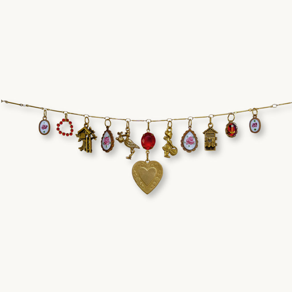 Close-up of the Imogen Necklace featuring the vintage heart pendant and red stone.