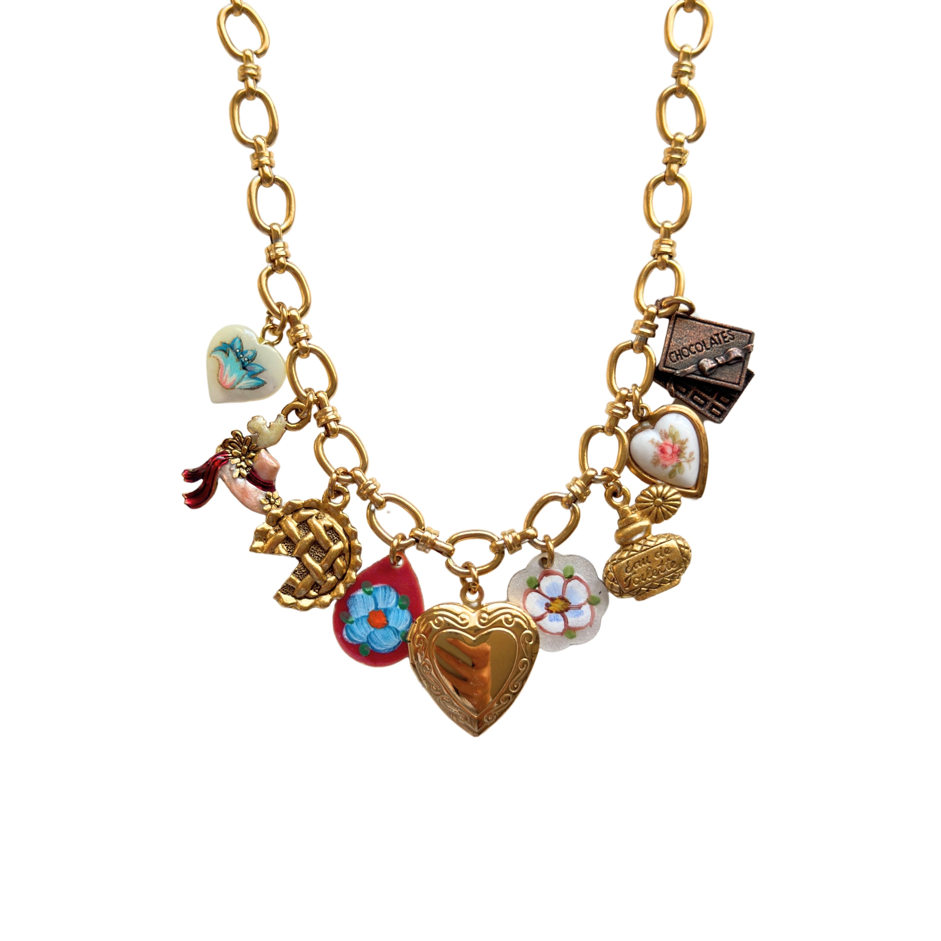 Close-up of hand-painted hat and mother of pearl heart charm