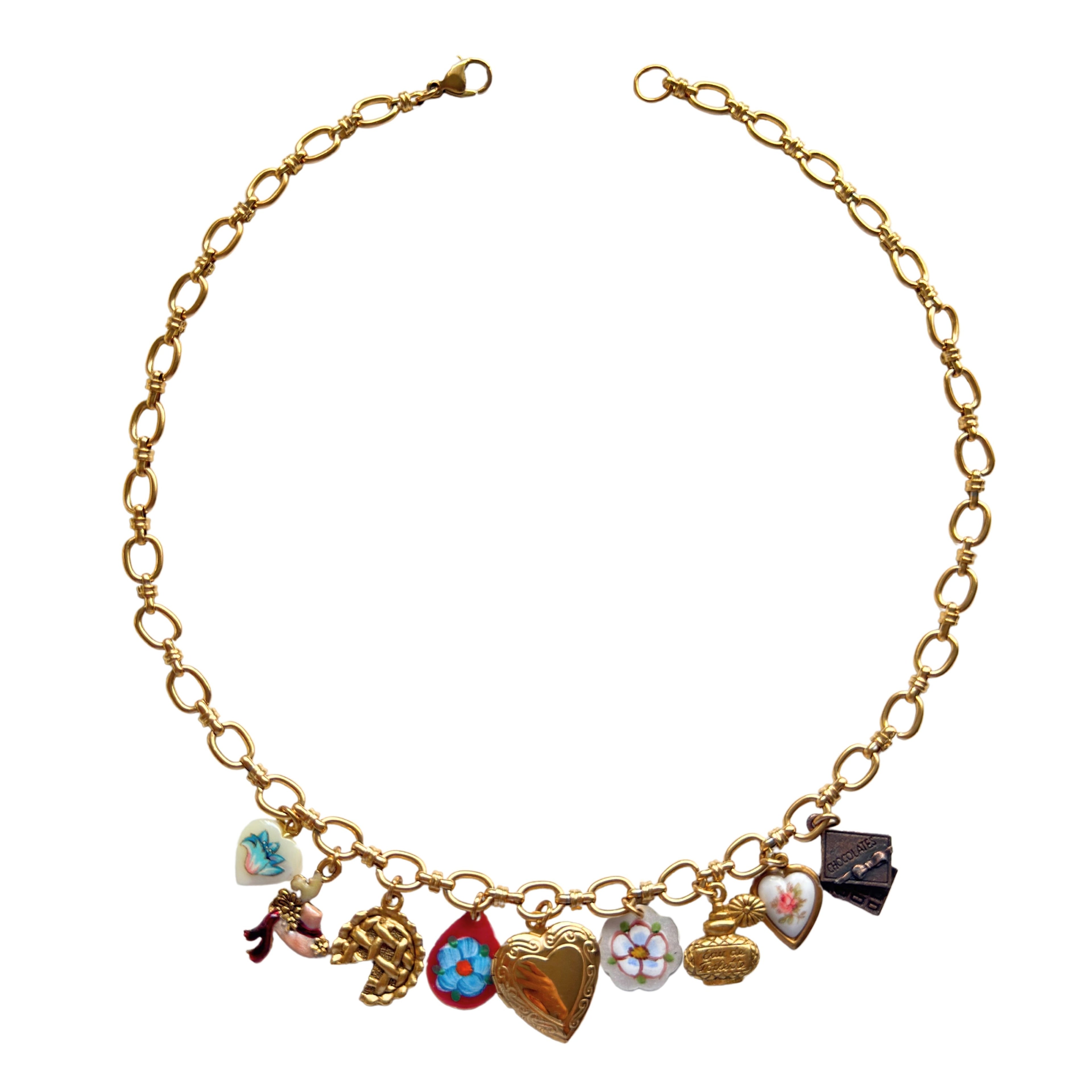 Isadora Necklace flatlay with gold pie and perfume charms