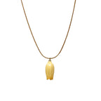 Isla Necklace flatlay with yellow flower charm