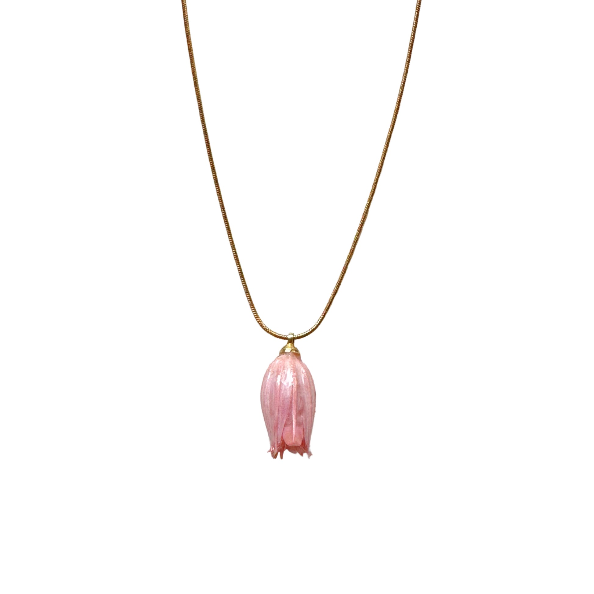 Isla Necklace flatlay with pink flower charm