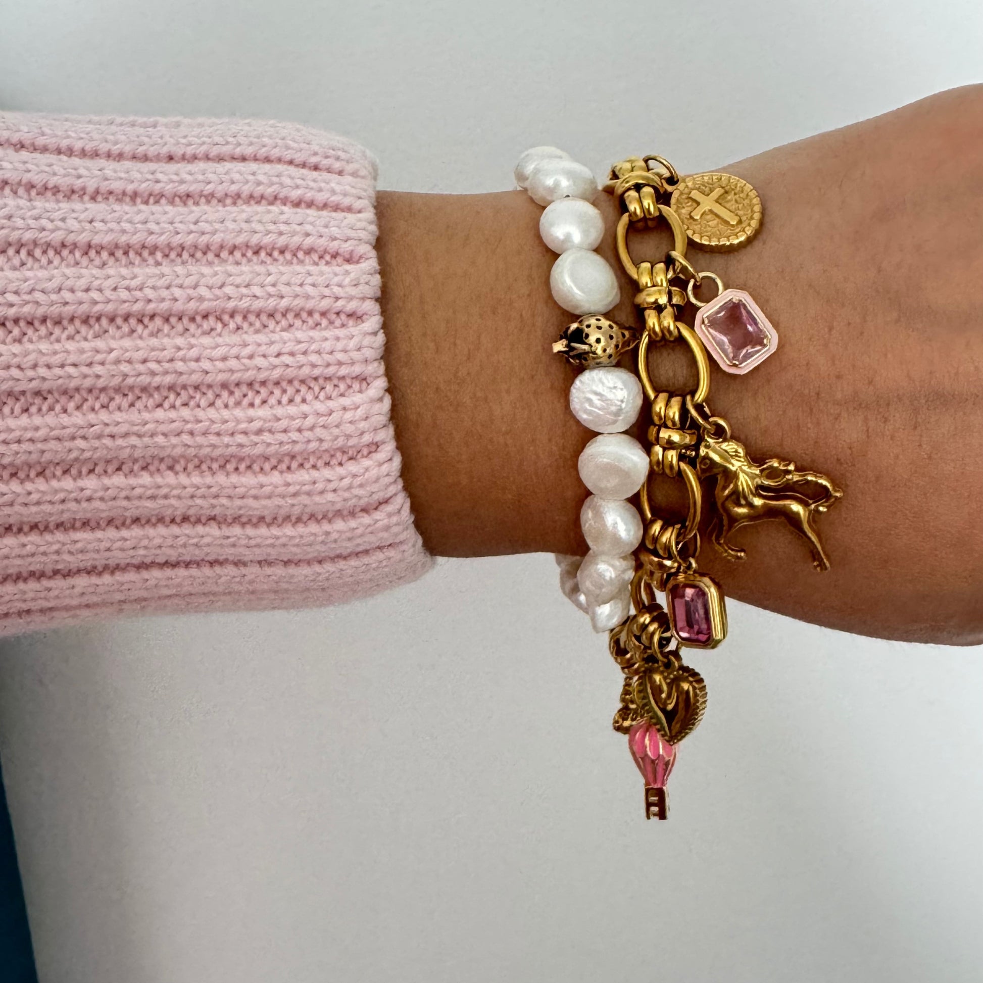 Close-up of 7.5-inch gold charm bracelet featuring elegant sailor clasp