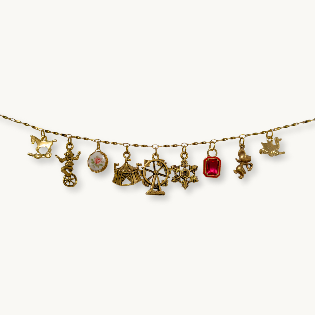 Close-up of the Kayla Necklace featuring its gold twist link charm chain.