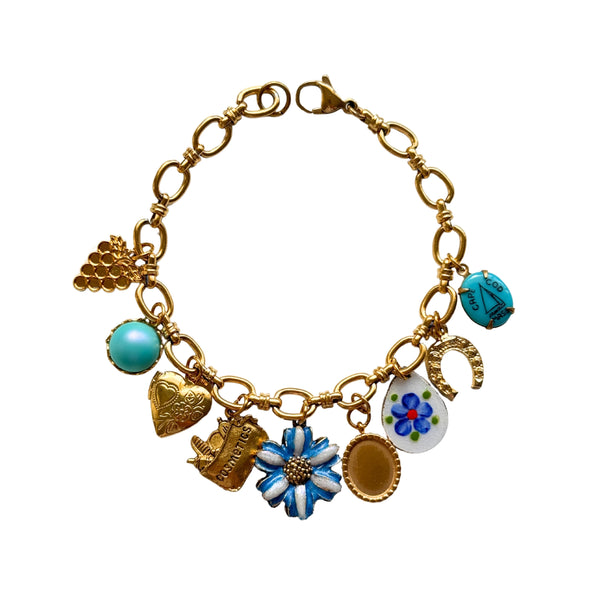 Close-up of hand-painted blue flower and heart locket charms